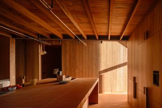 burnt earth beach house living space in timber cladding