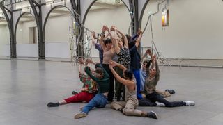 group of dancers perform in exhibition hall