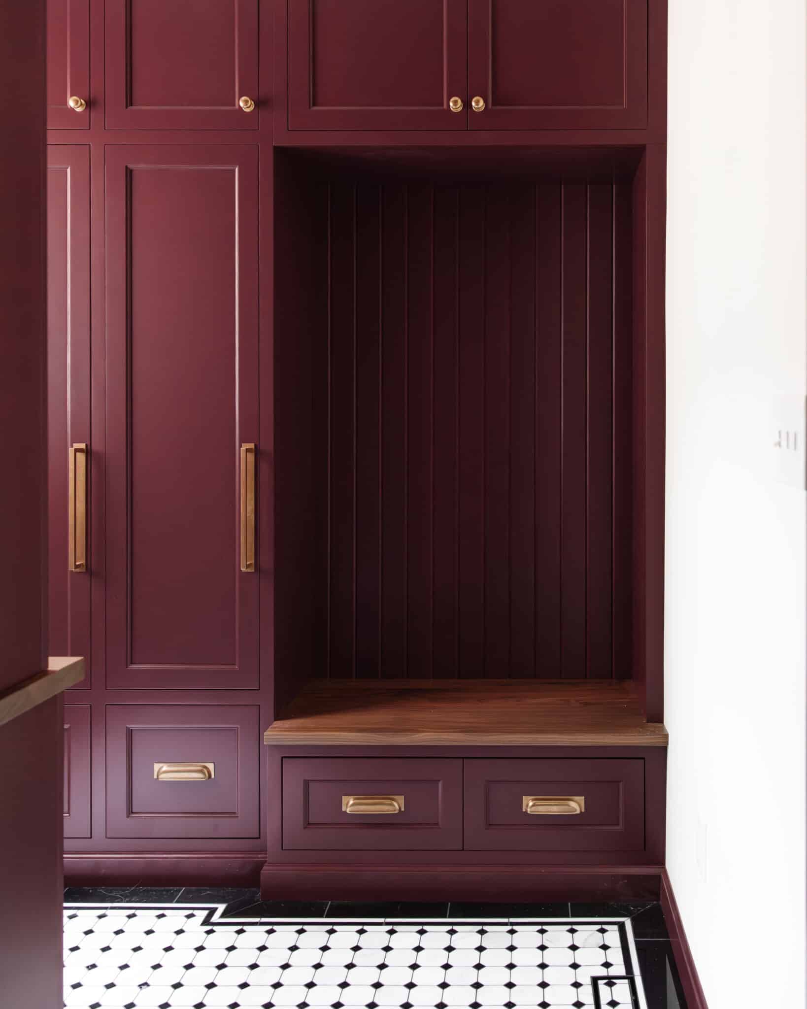 Chris Loves Julia | Mudroom with red cabinets finished with custom trim