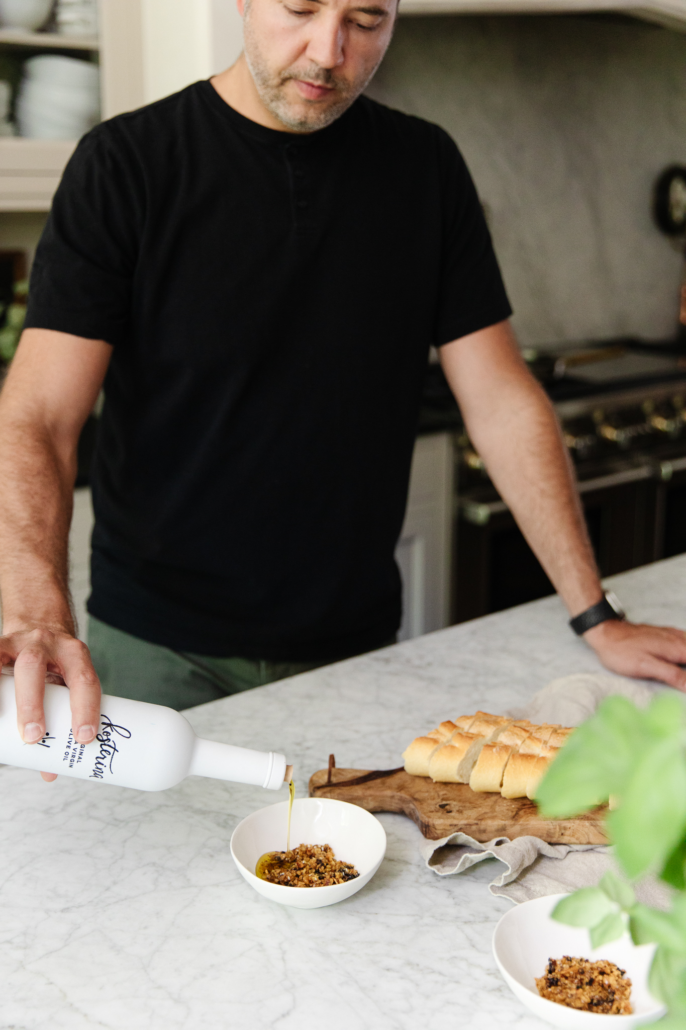 Chris Loves Julia | Chris pouring Kosterina Original Olive Oil into a small bowl with chile flakes