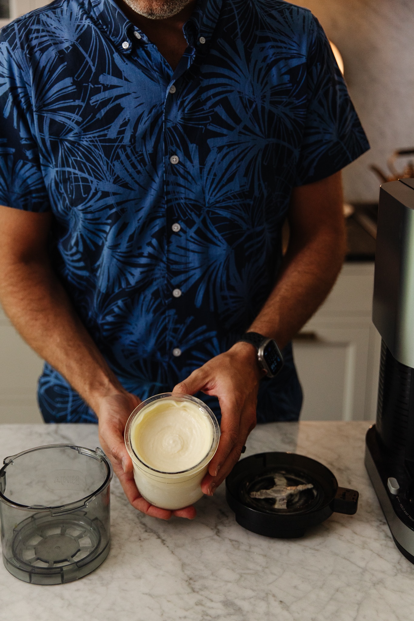Chris Loves Julia | Chris holding a pint container of a frozen virgin Piña Colada dessert