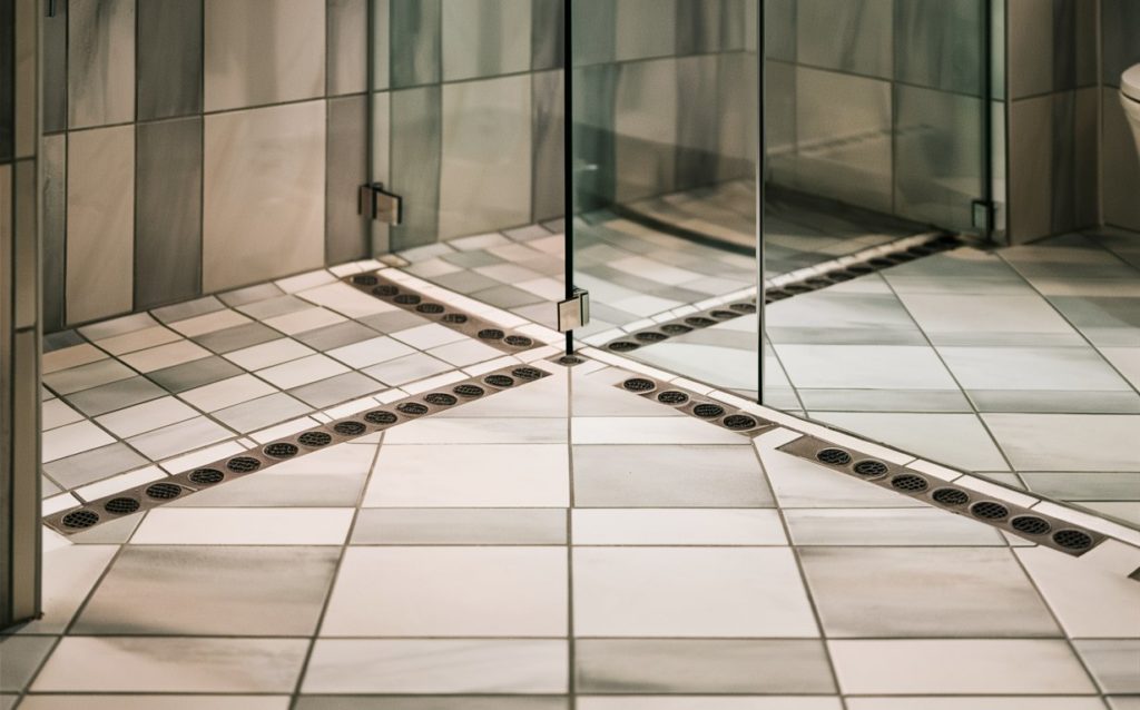 Modern bathroom with tiled walls and a clear glass shower enclosure.