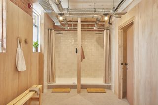 the loom club interiors with timber cladding and soft curtains dividing the space