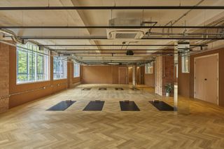 the loom club interiors with timber cladding and soft curtains dividing the space