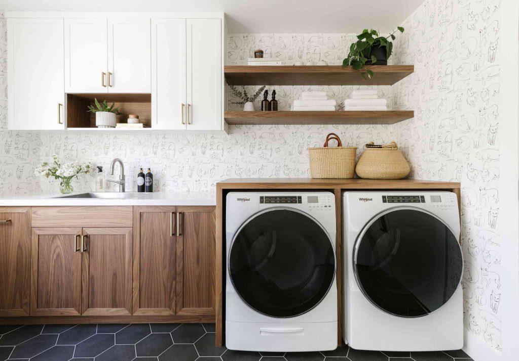 Laundry room with washer and dryer, and a sink with a faucet.
