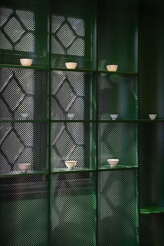 green metal shelving in Zhang Taiyan by Tsing-Tien Making