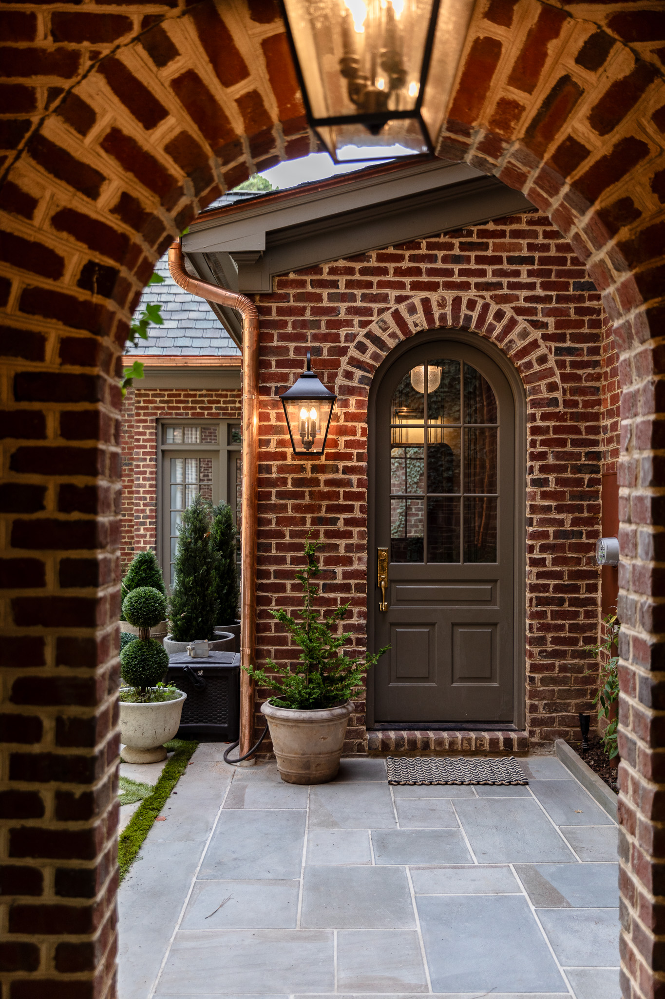 Mud room entrance with potted plants next to the door