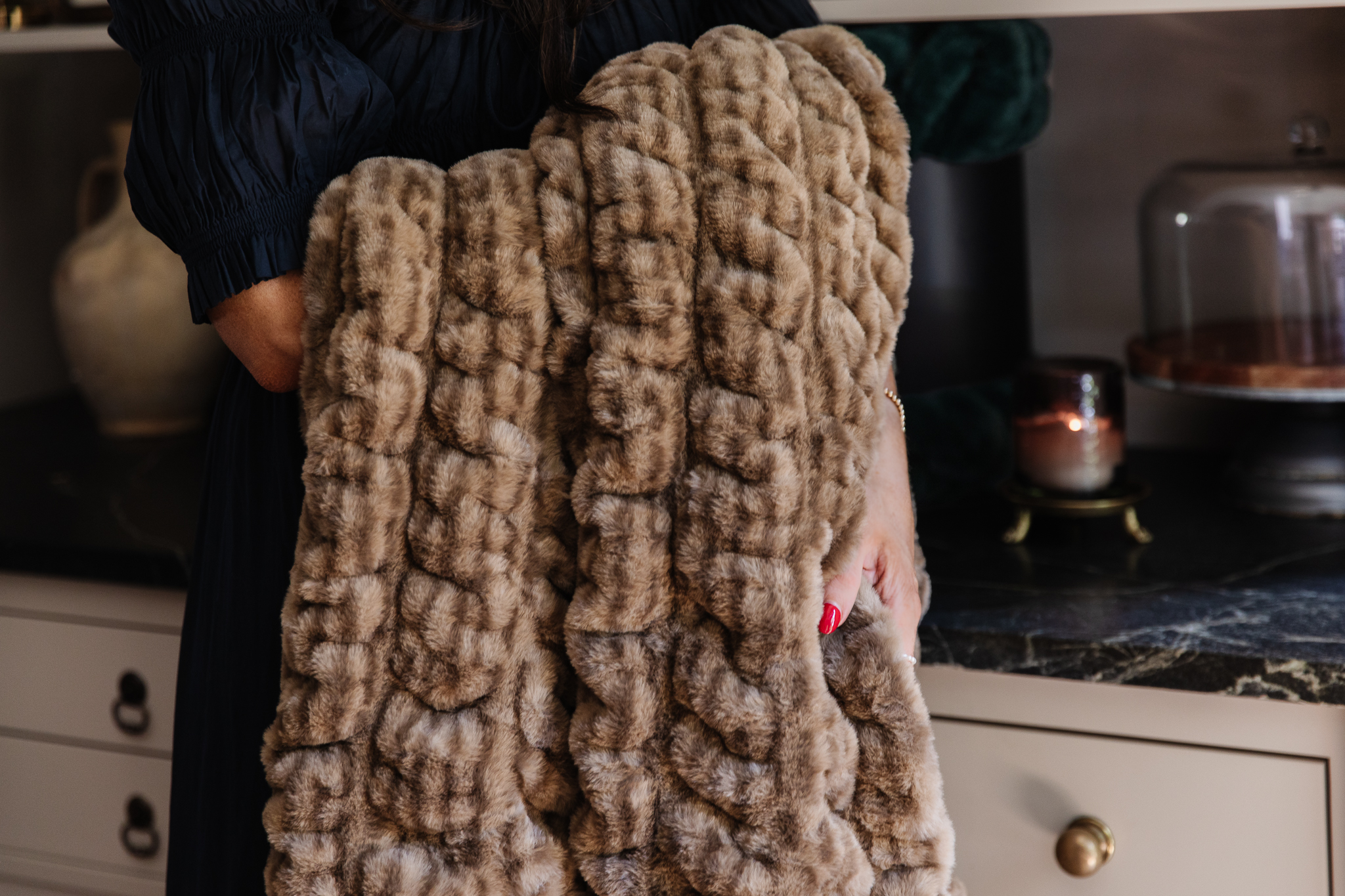 Chris Loves Julia | Julia holding a new CLJ x Lola Blanket in color Corduroy