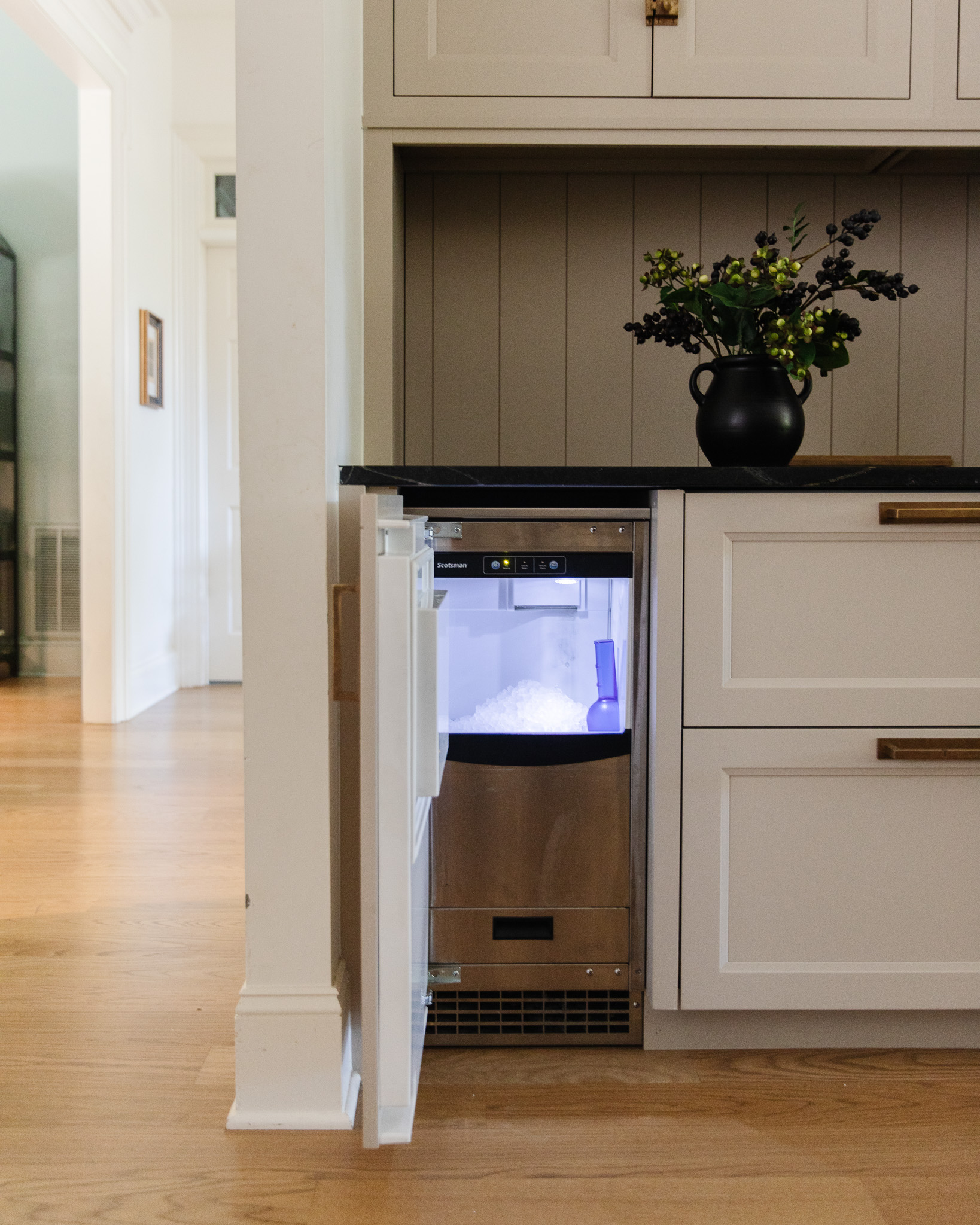 Pebble ice maker under a kitchen counter