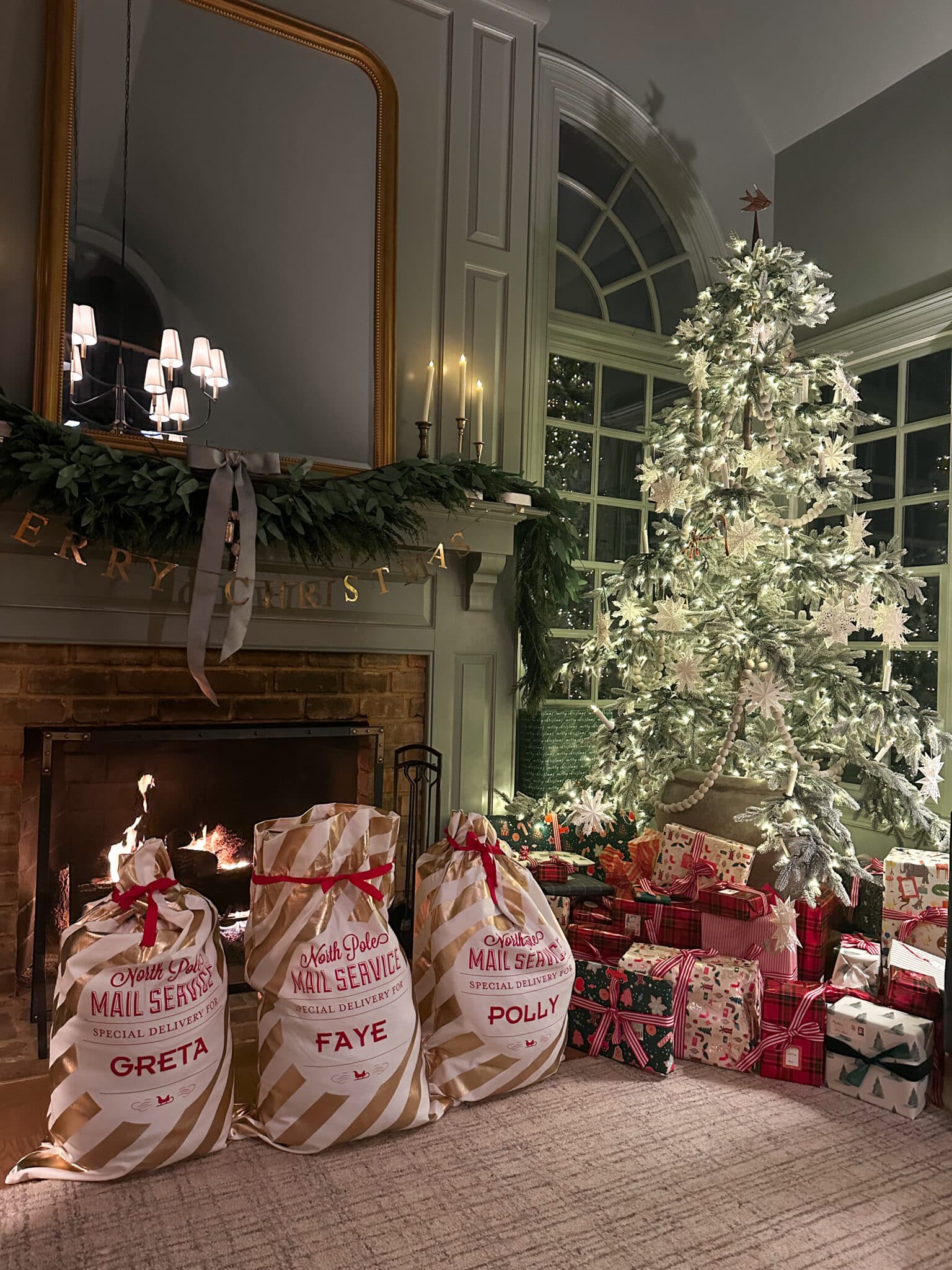 Christmas presents and big Santa bags in front of a hearth