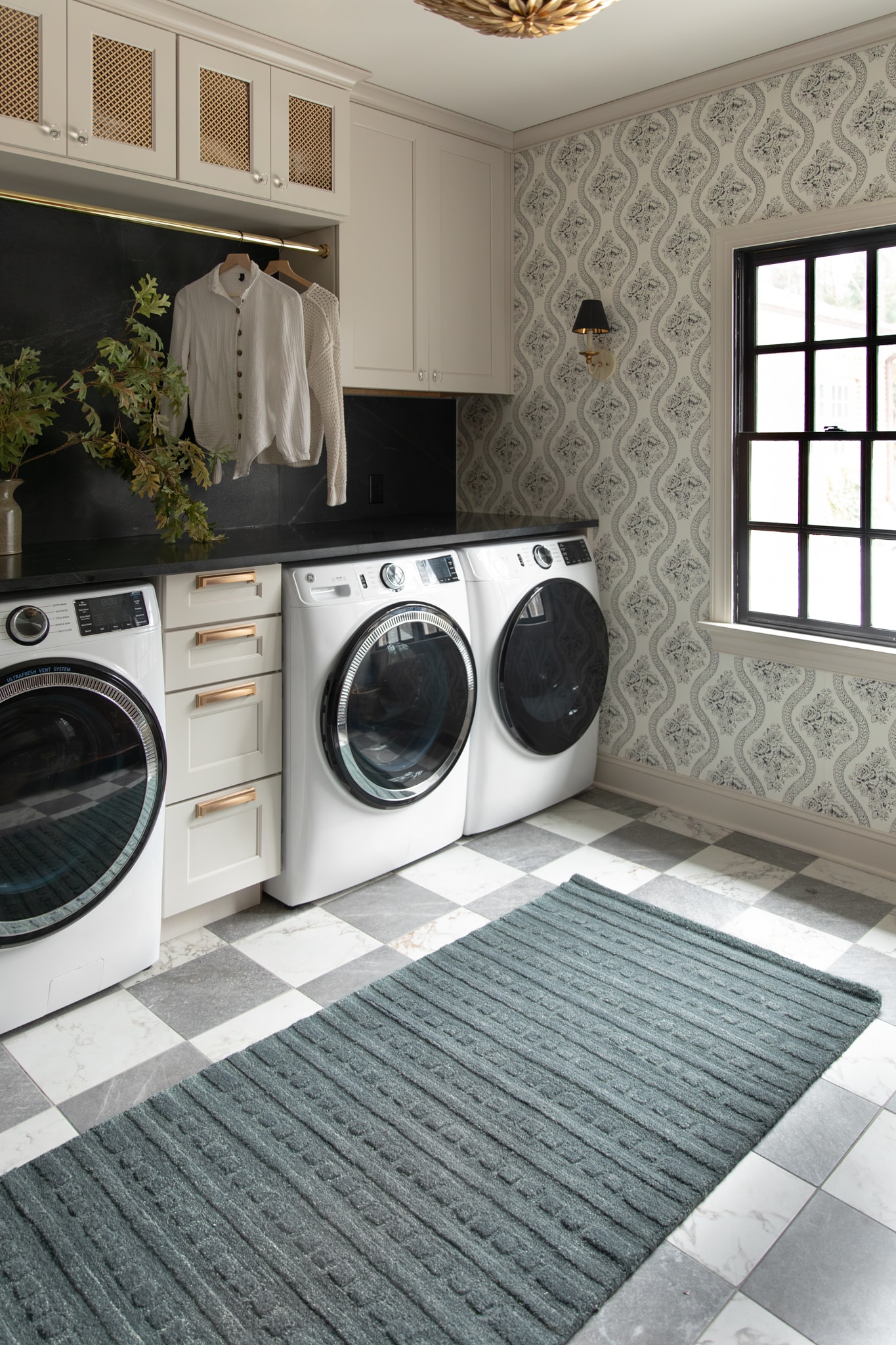 Modern black and white laundry room with blue area rug