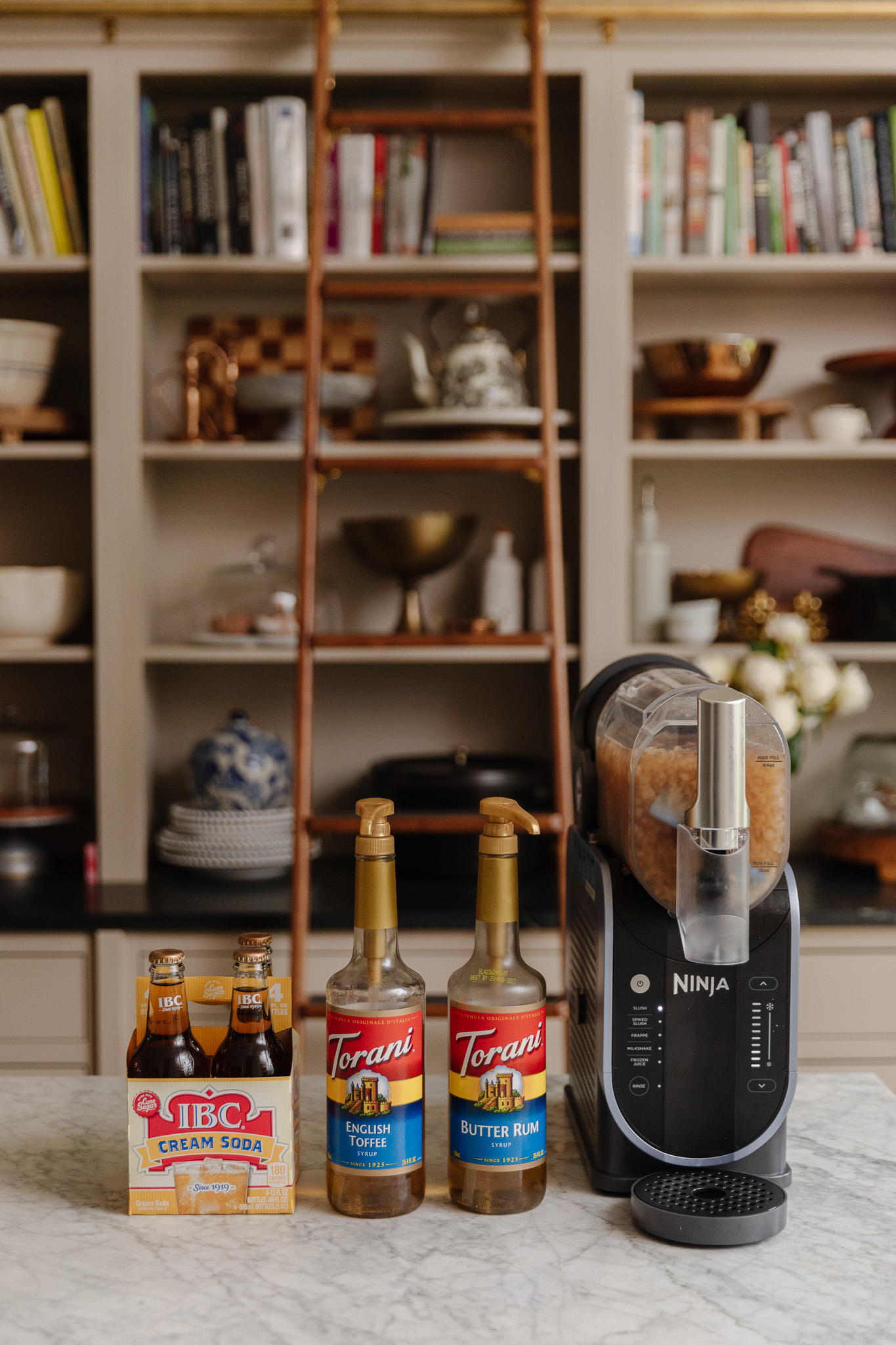 Torani syrups, cream soda, and the Ninja SLUSHi machine on a counter