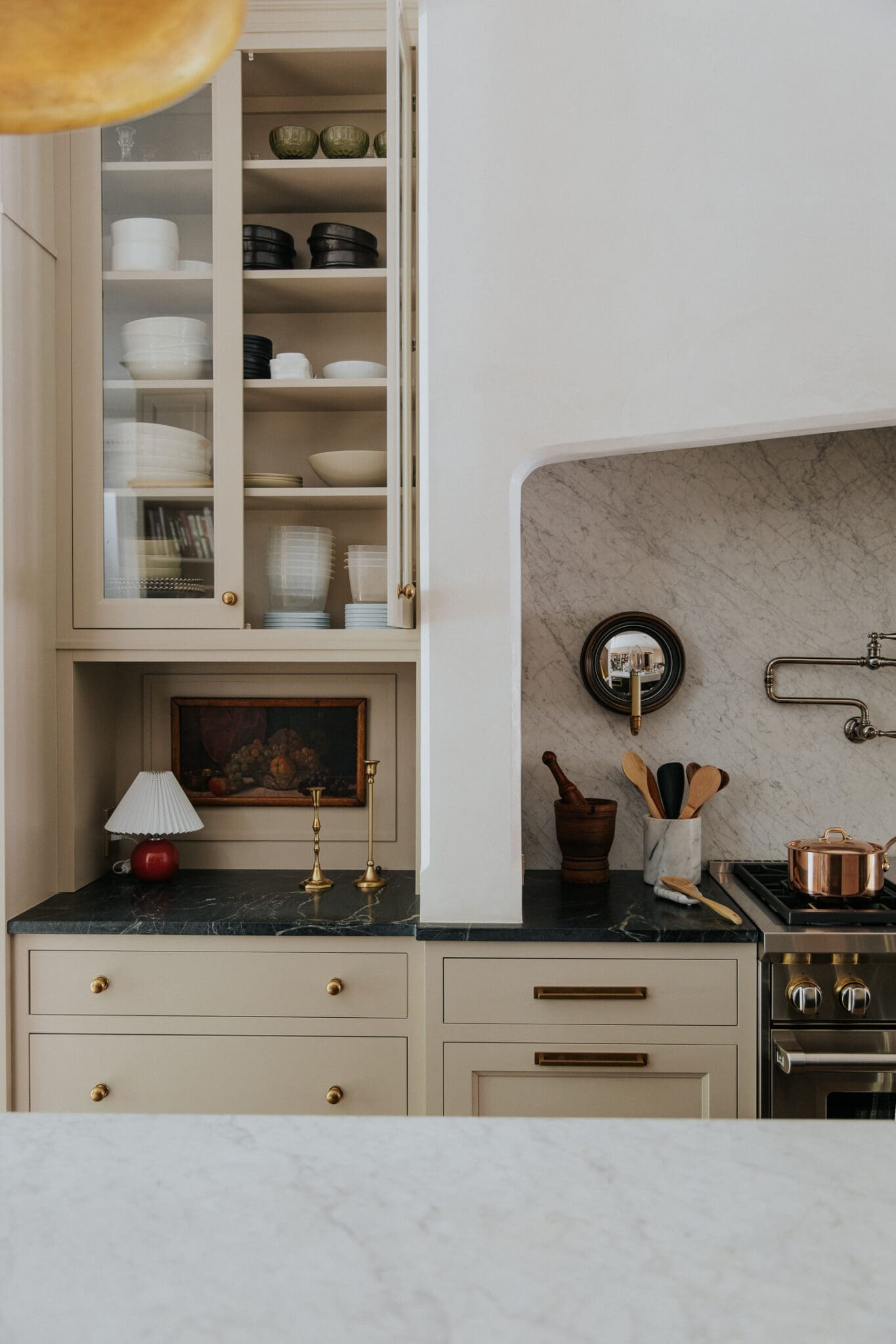 The counters next to the range oven and the plastered hood