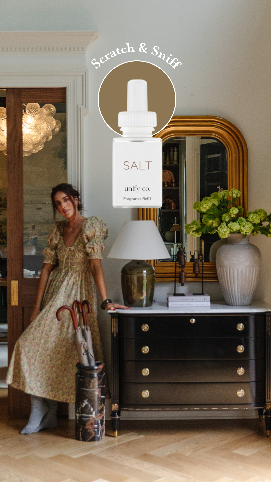 Julia in a floral dress leaning on her entry dresser with a superimposed Pura fragrance bottle: Scratch & Sniff Unify Co's Salt