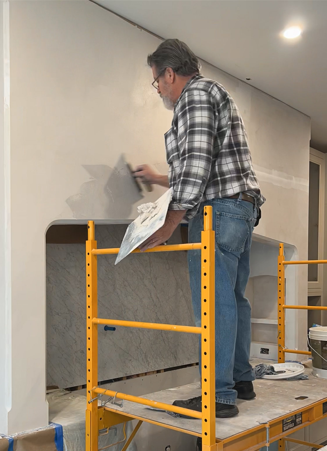 Jerry applying plaster to the range hood