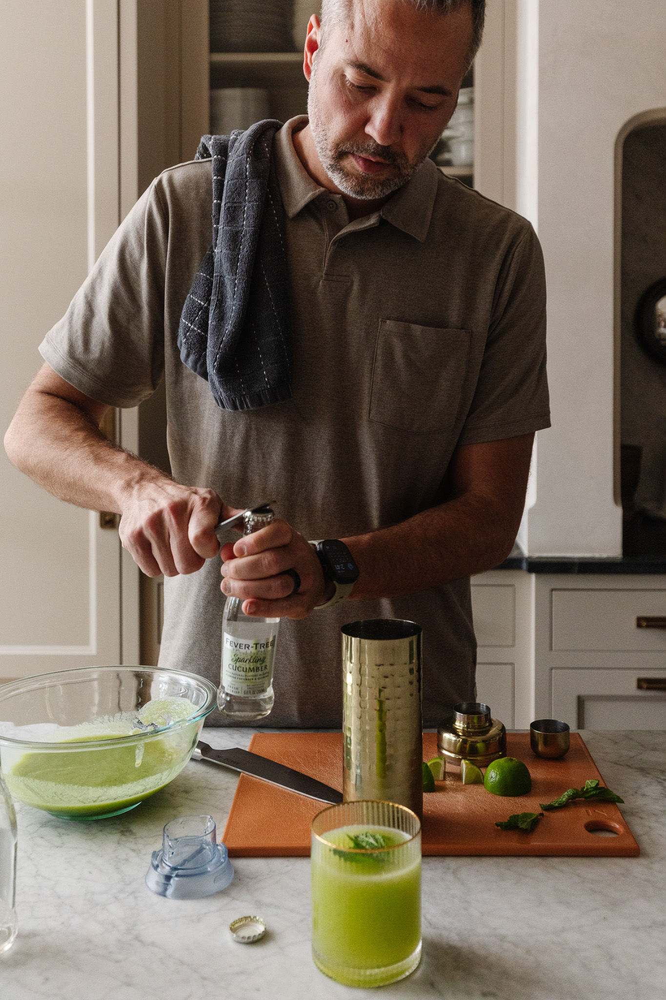 Chris opening a bottle of cucumber soda water to make a spritzer