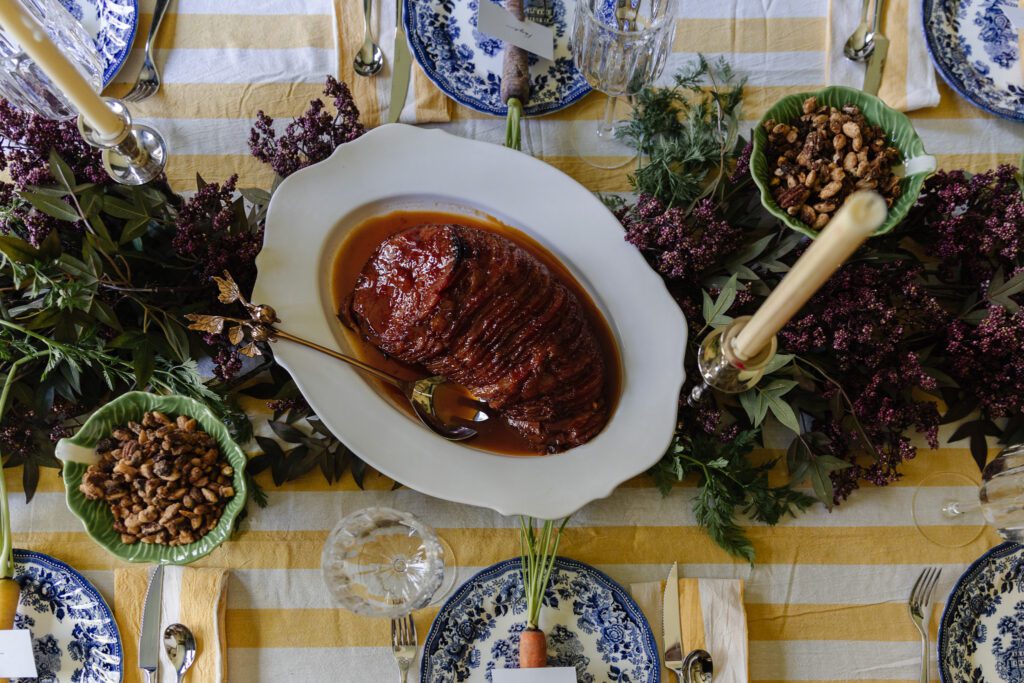 Apricot-glazed ham on a serving platter on an Easter table