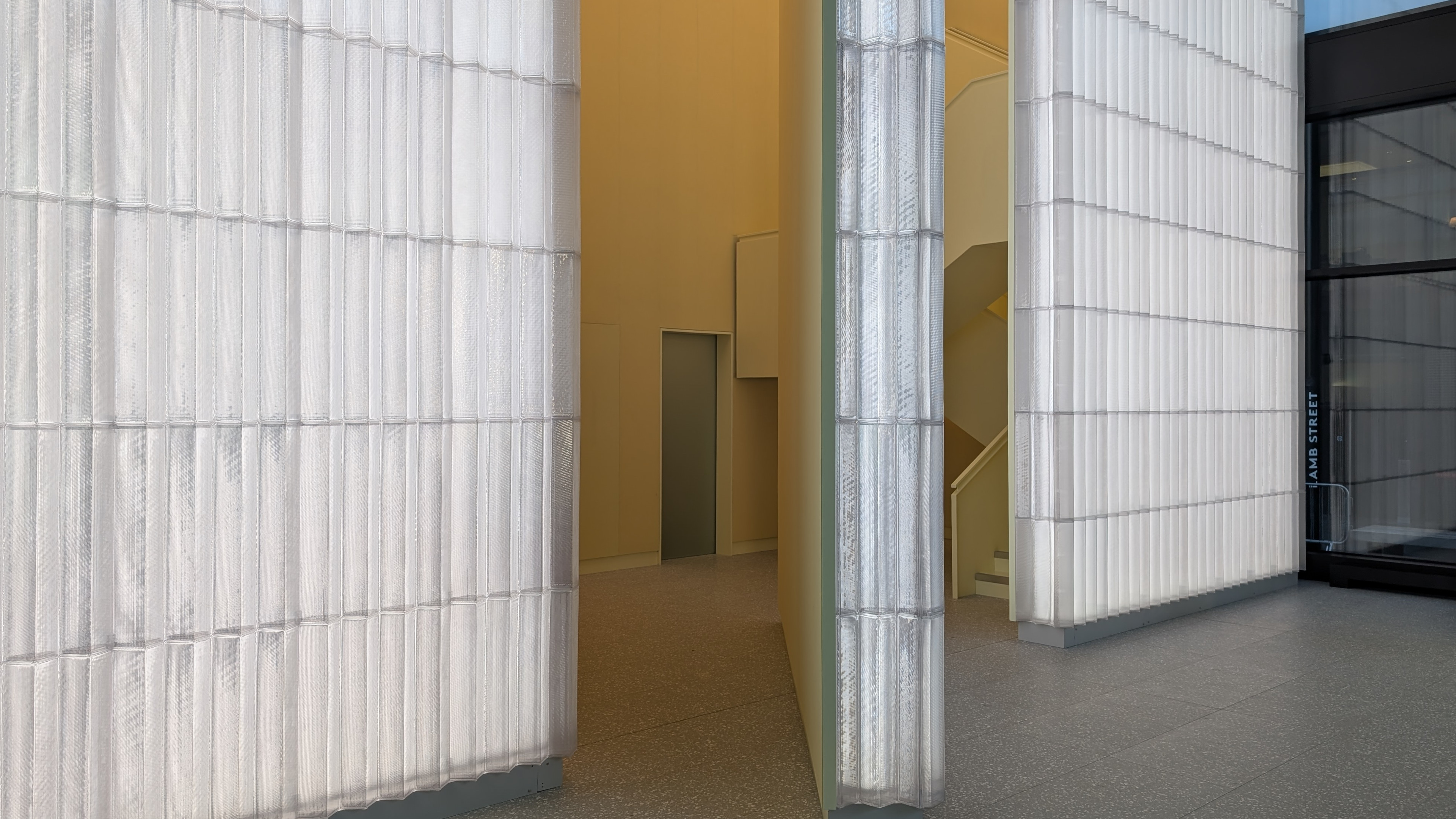 The 8m high glass wall 'pivots' to lead through to the stairs to the scanning suites