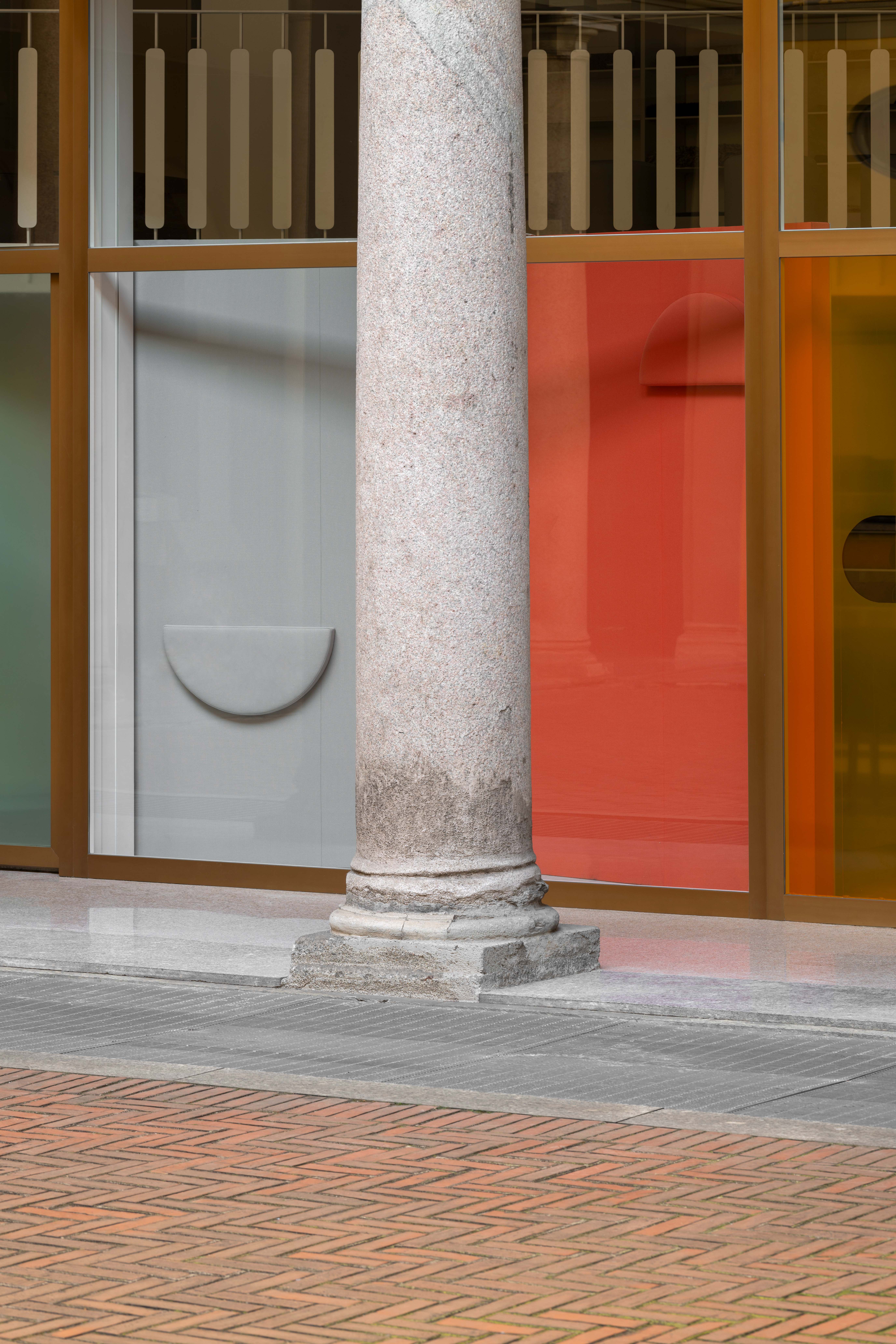 Showroom facade featuring abstract shapes and shadows made using colourful textiles and coloured film