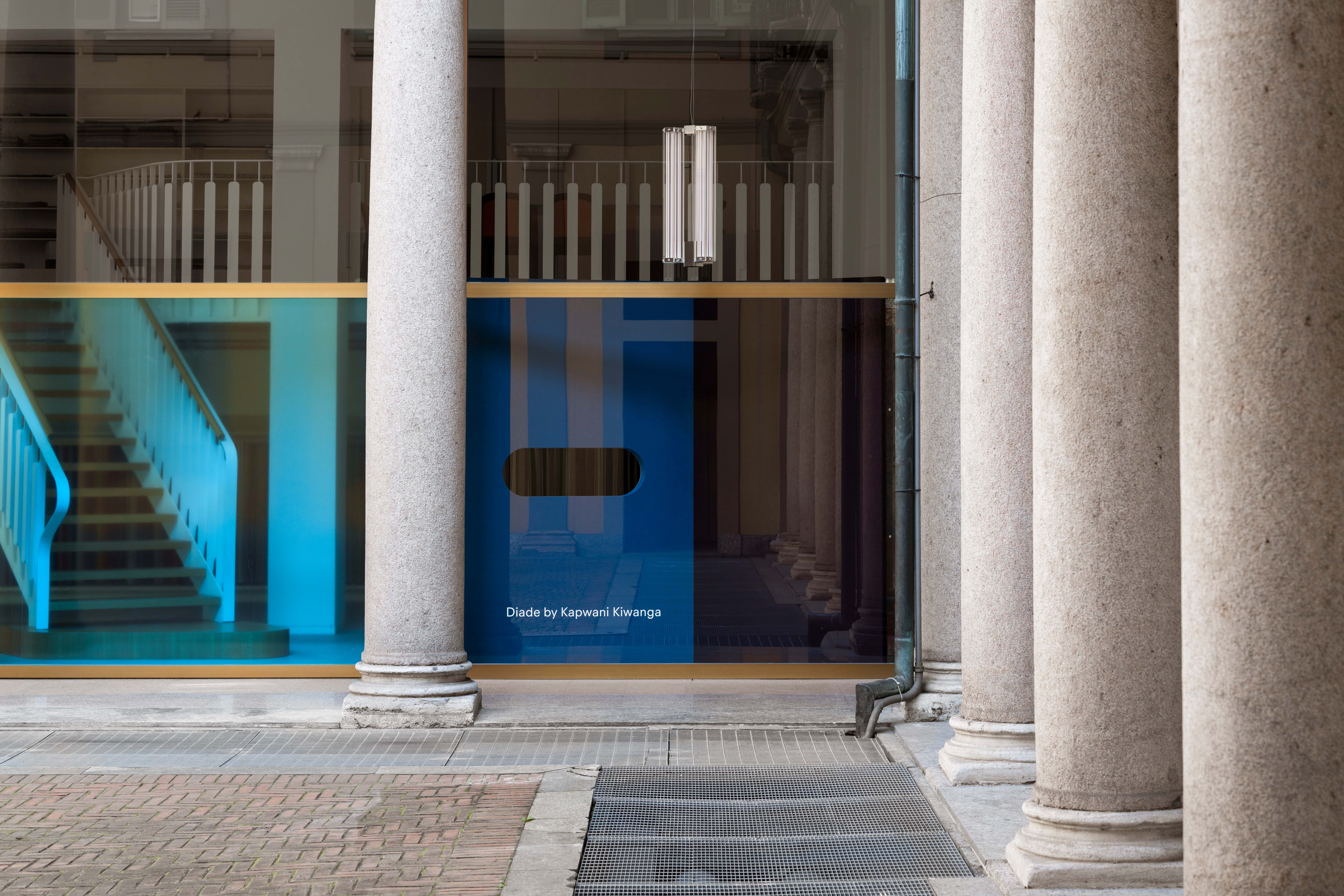 Showroom facade featuring abstract shapes and shadows made using colourful textiles and coloured film