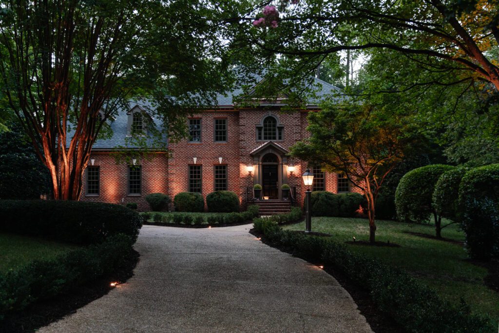 Up-lighting installed in front of a brick home