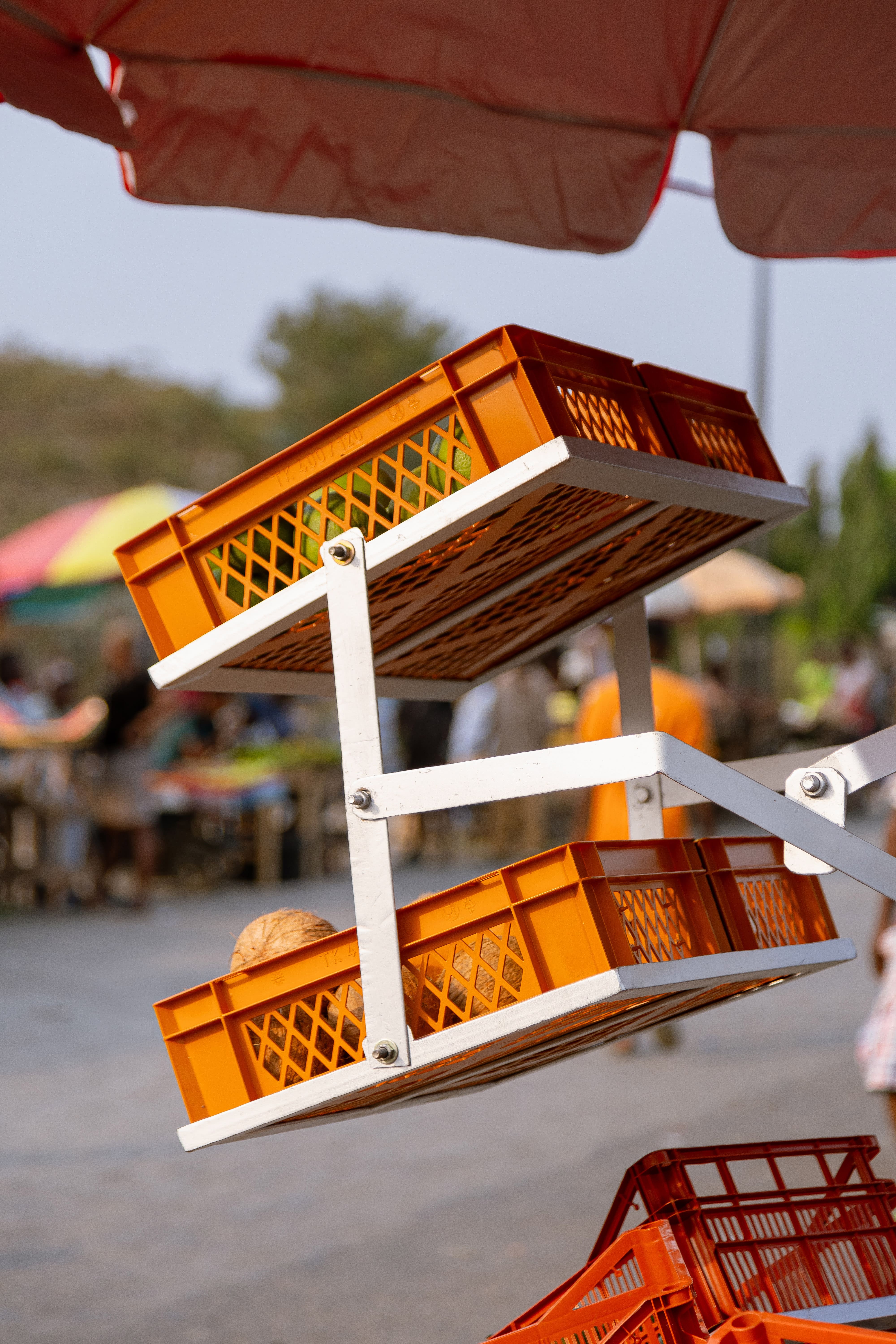 Metal street market stall with red umbrella