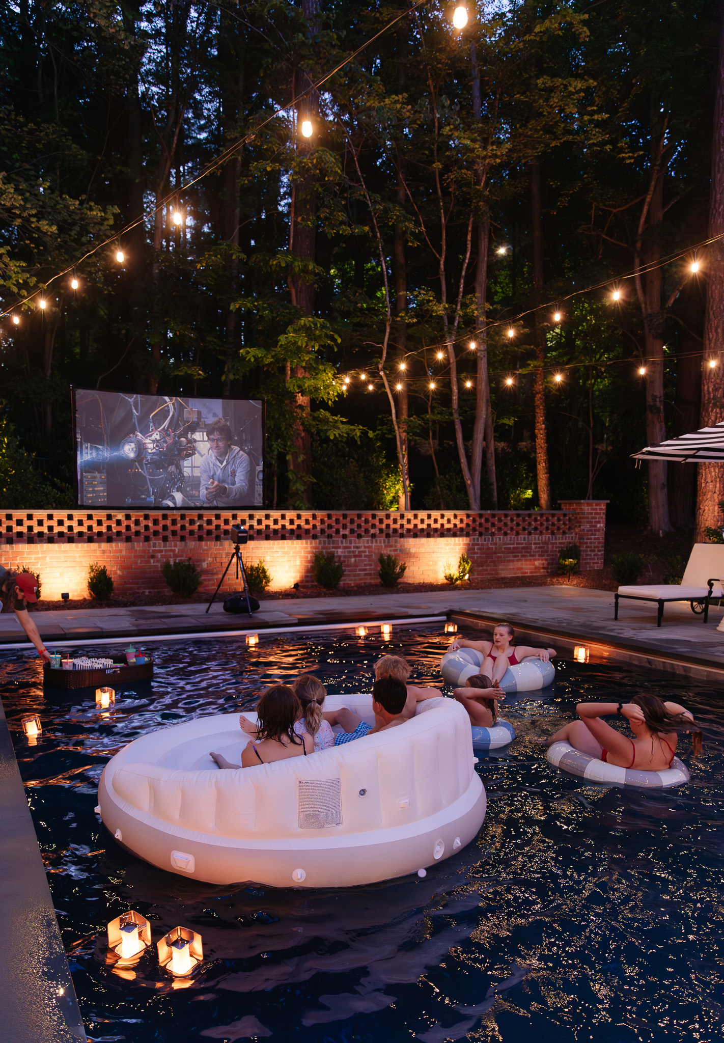 Accent string lights over the pool for an outdoor movie night