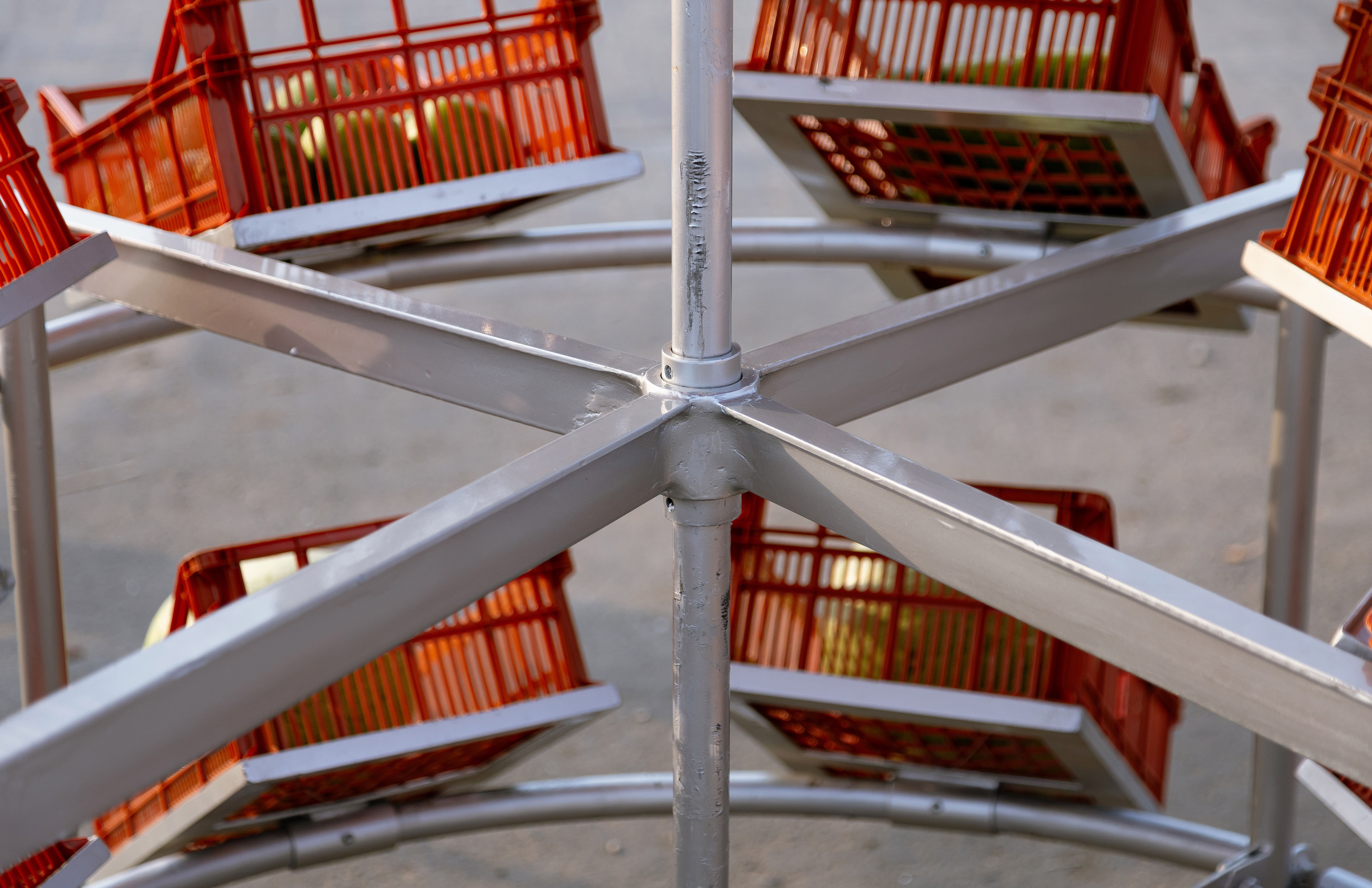 Metal street market stall with red umbrella