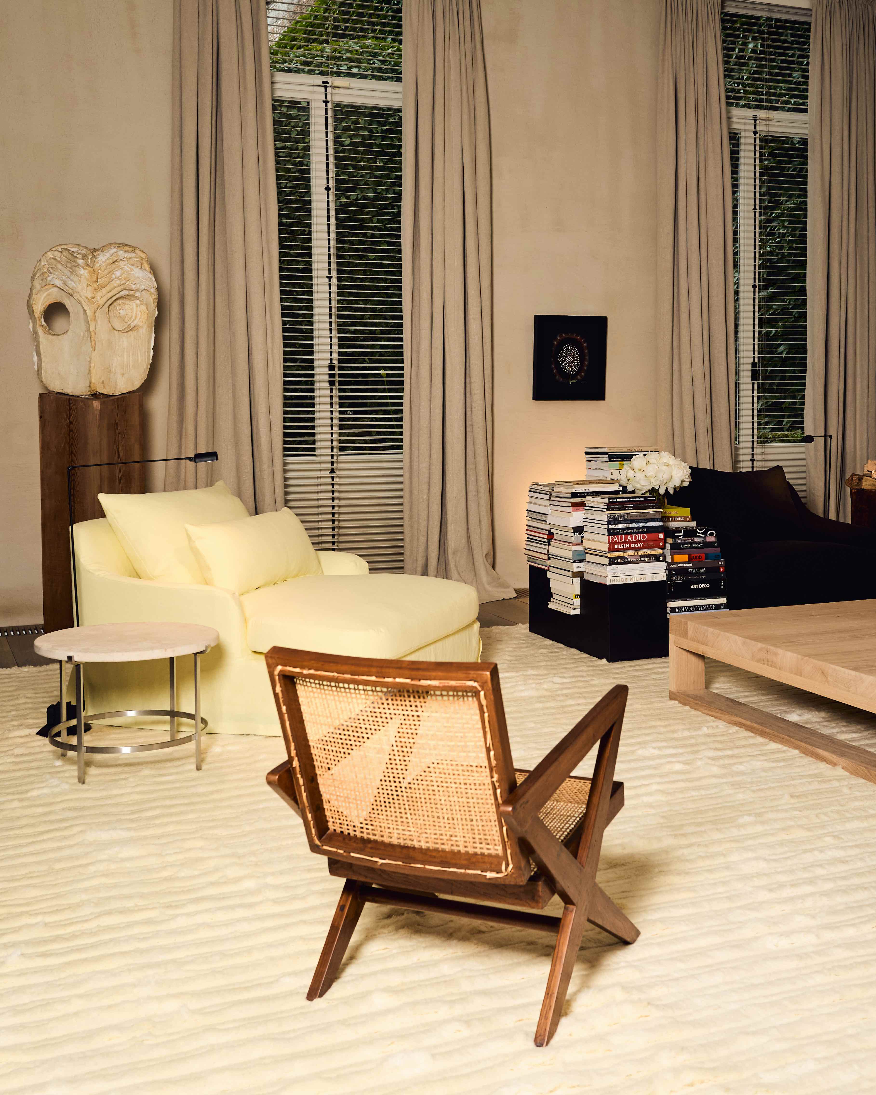 chairs, coffee table and white deep pile rug arranged in a living room