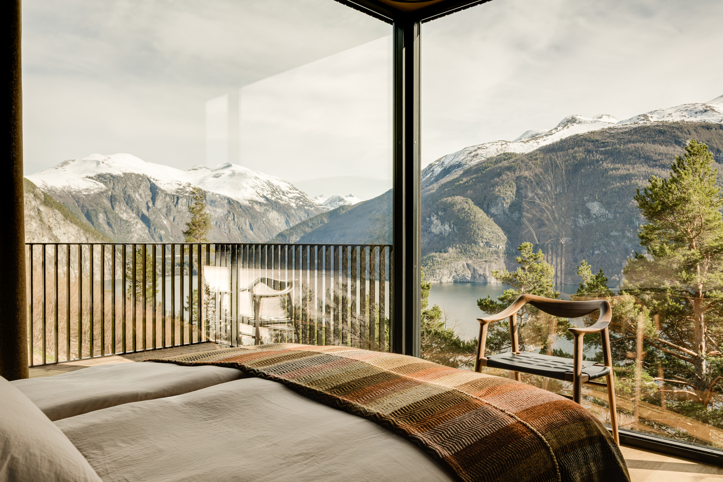 The primary bedroom occupies the corner of the plan and has its own terrace