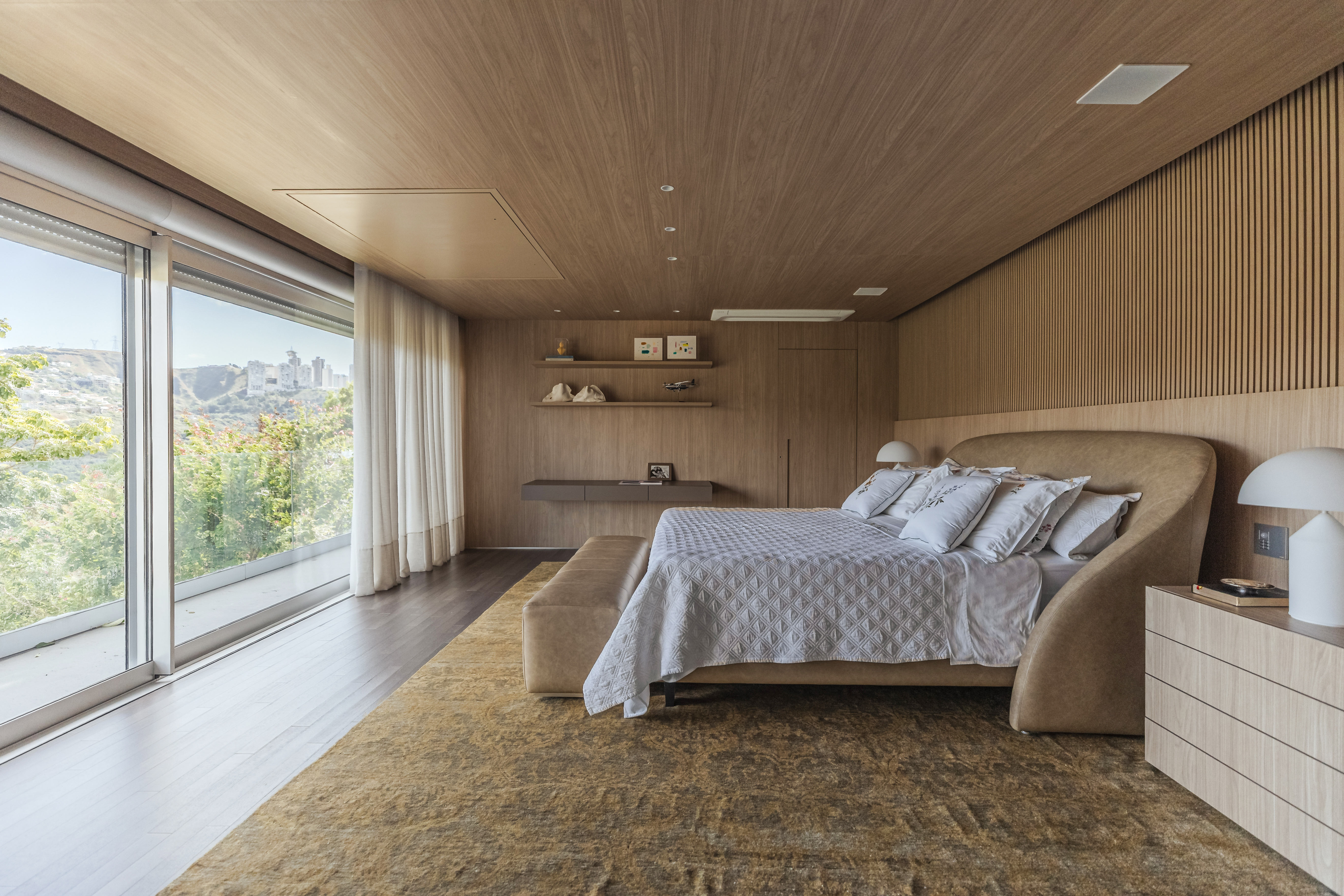 The wood-lined primary bedroom suite