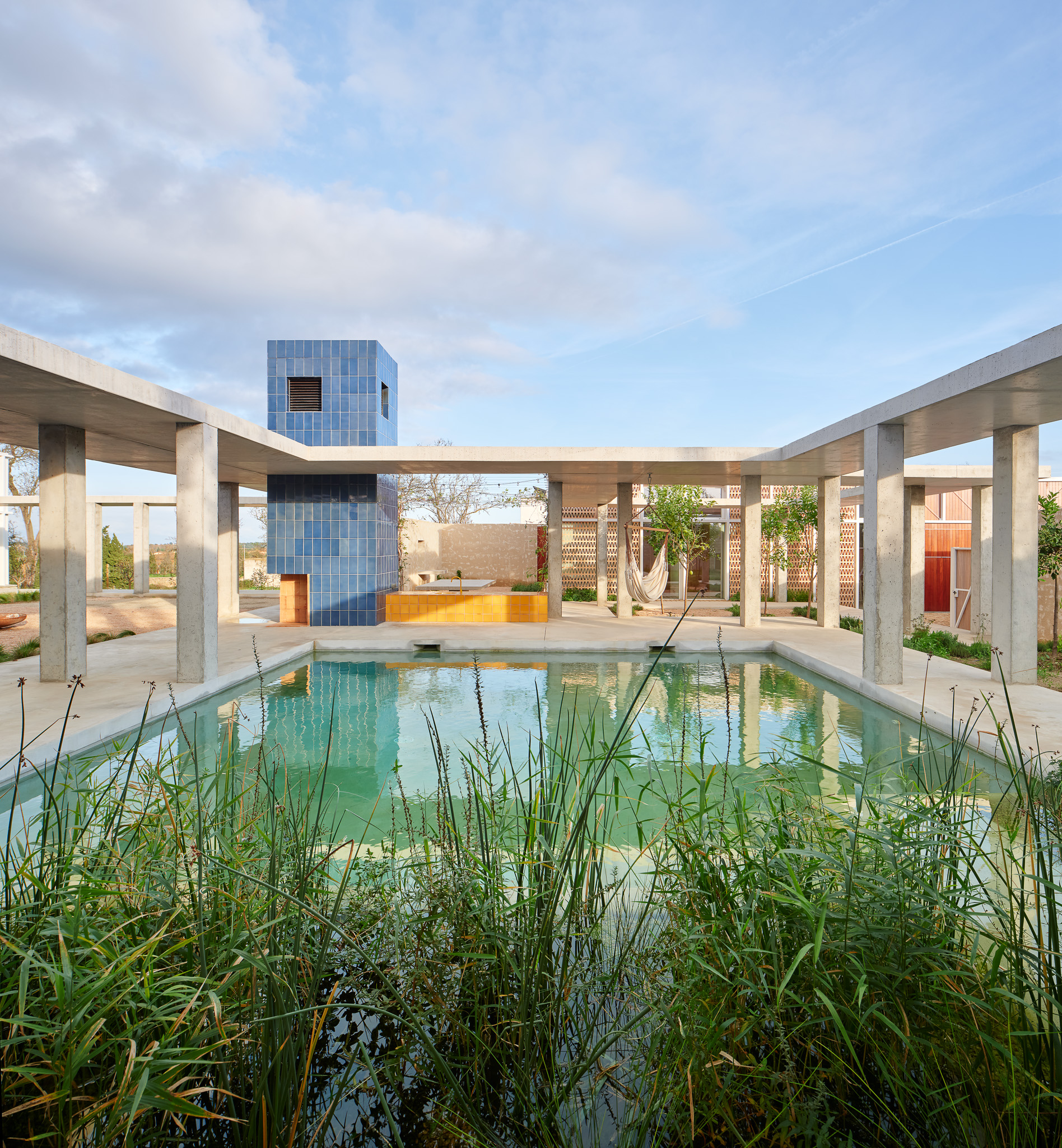 Looking west past the pool to the outdoor kitchen and dining area