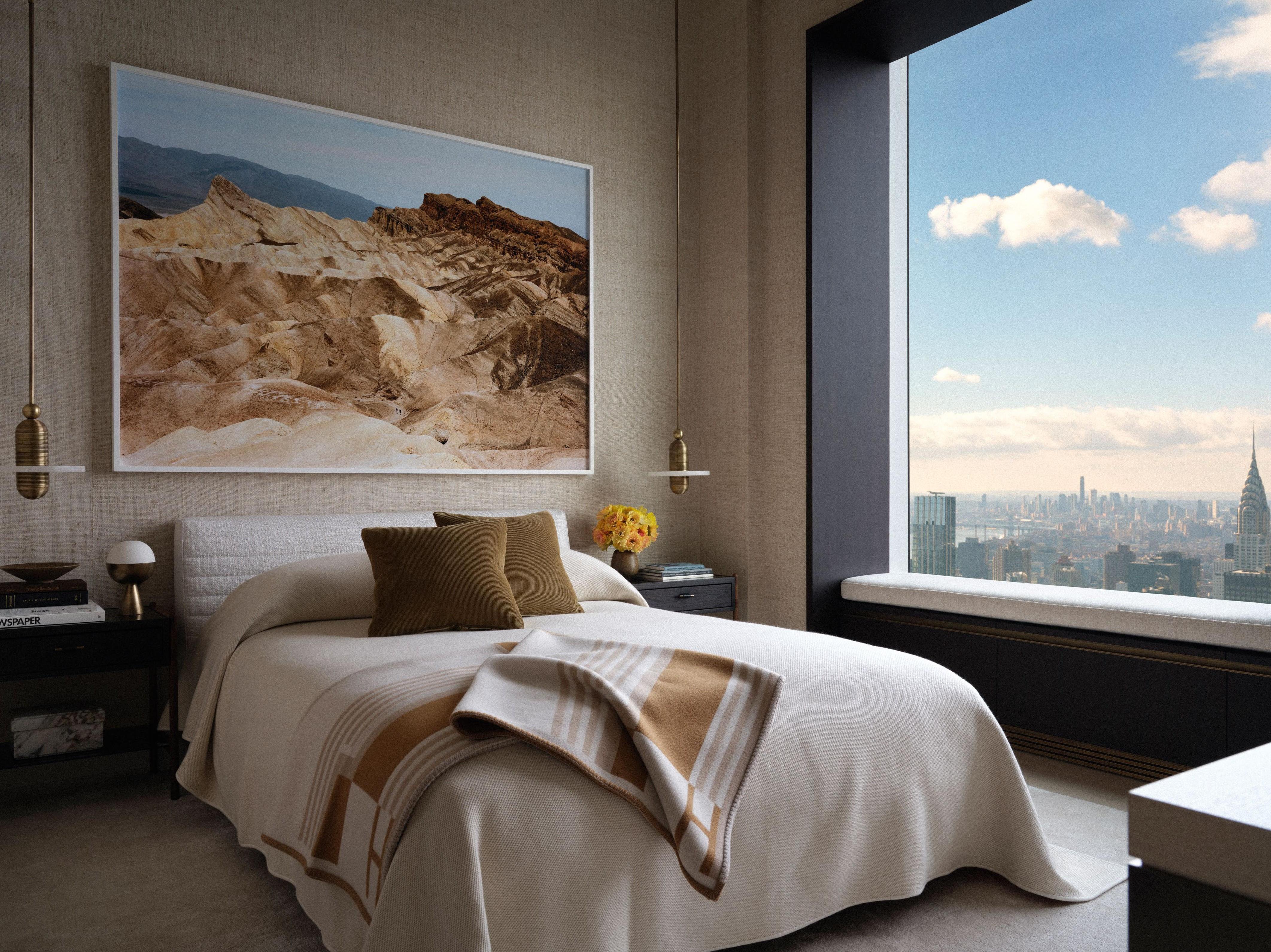 A ‘Roger’ bed by Rodolfo Dordoni for Minotti in the guest bedroom lies between a pair of ‘Median Mono’ pendants by Apparatus underneath Untitled, (Zabriskie Point), Death Valley National Park, California, 2021, by Victoria Sambunaris