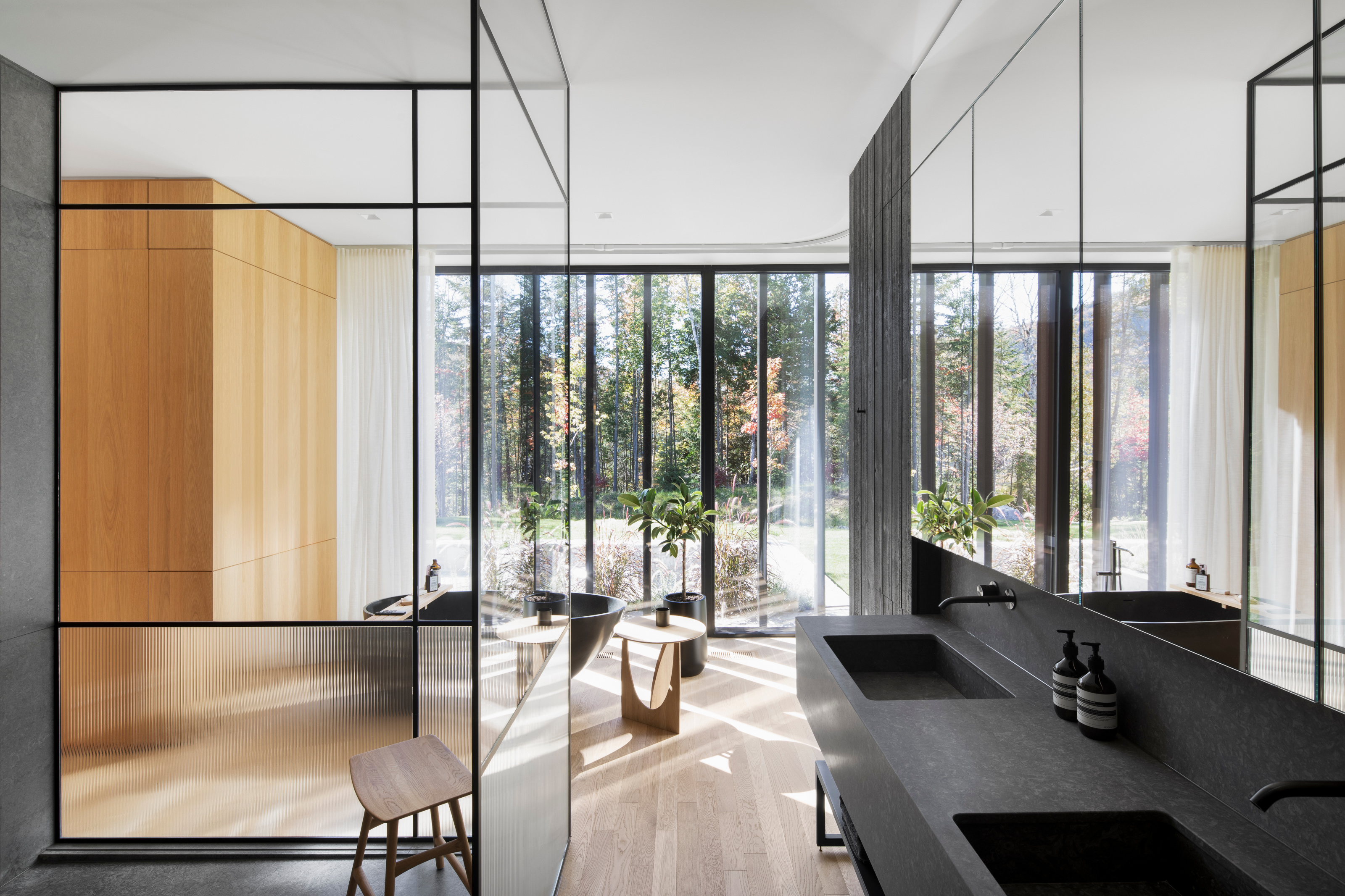 The primary ensuite has views to the forest surrounding the property