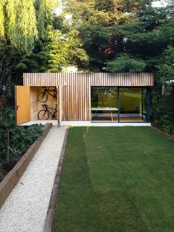 Wooden outhouse with integrated bicycle storage compartment