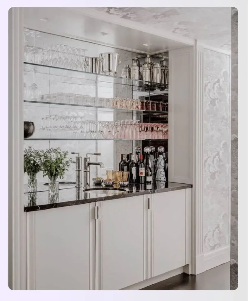 A mirrored backsplash behind shelves of liquor bottles
