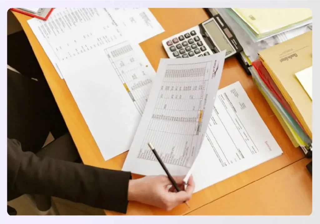Designer reviewing financial documents for a loan
