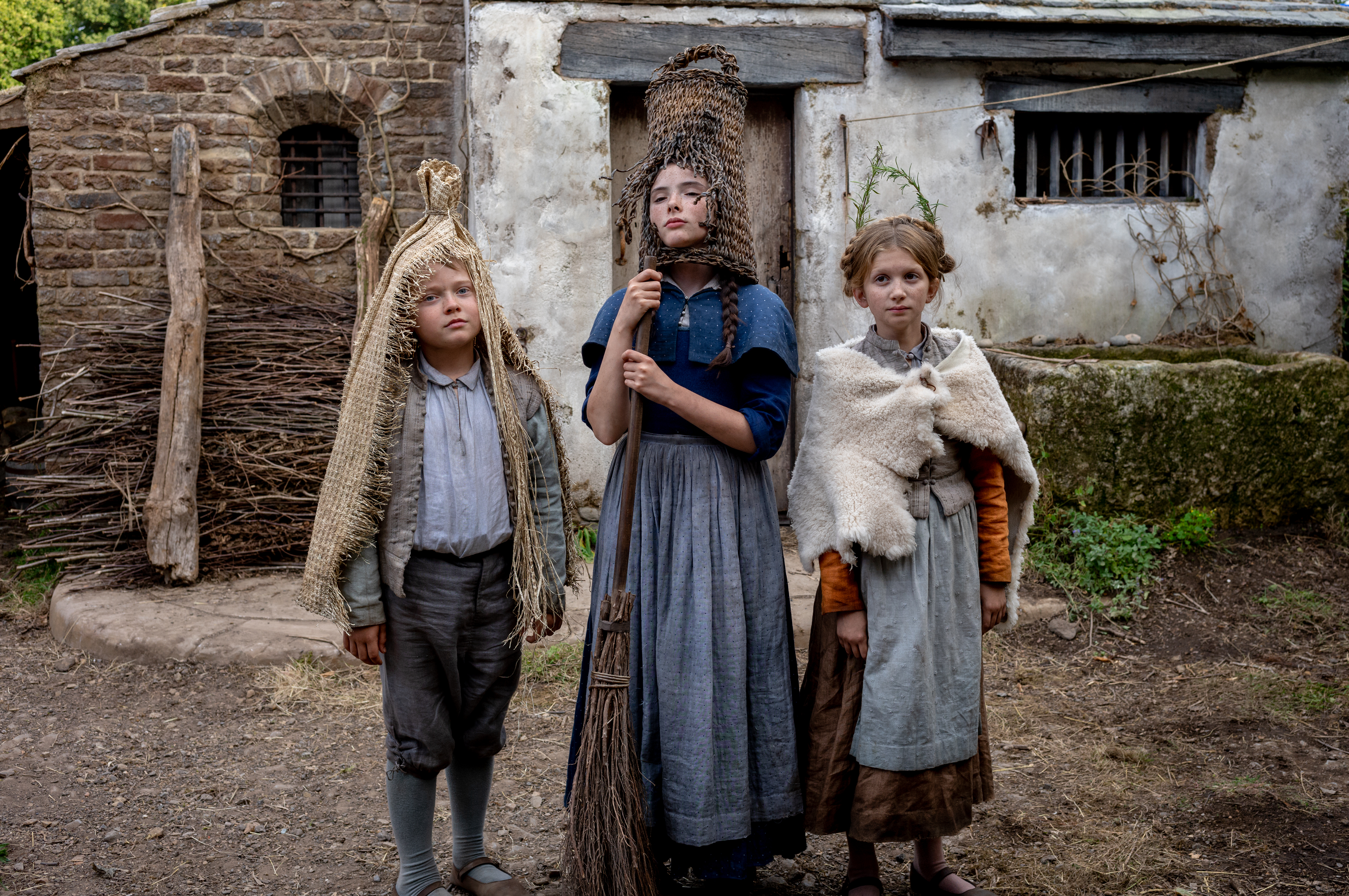 Three child actors playing Shakespeare's children in a still from the film Hamnet