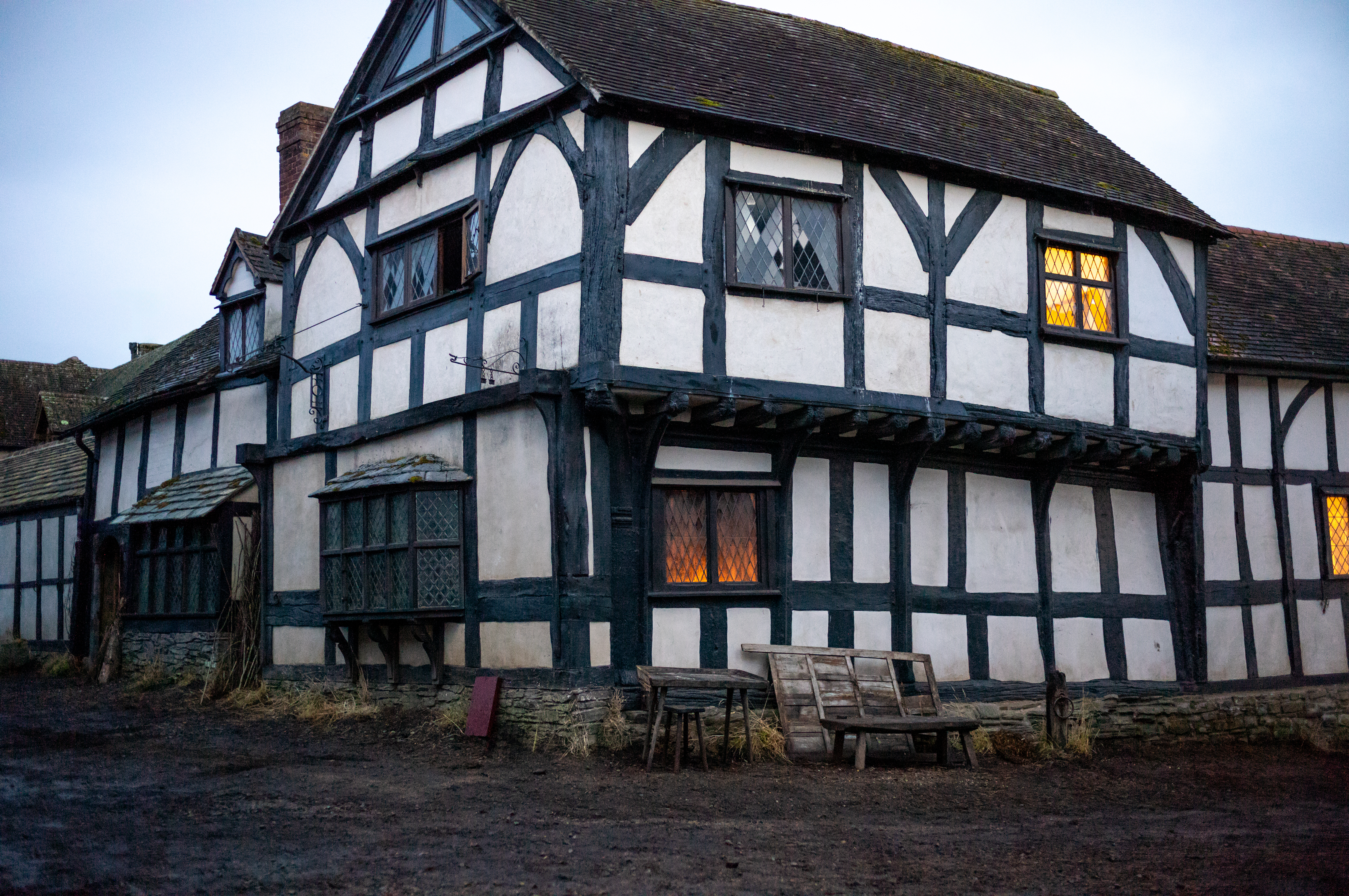 White-walled Tudor-era home with black timber framing, from the film Hamnet