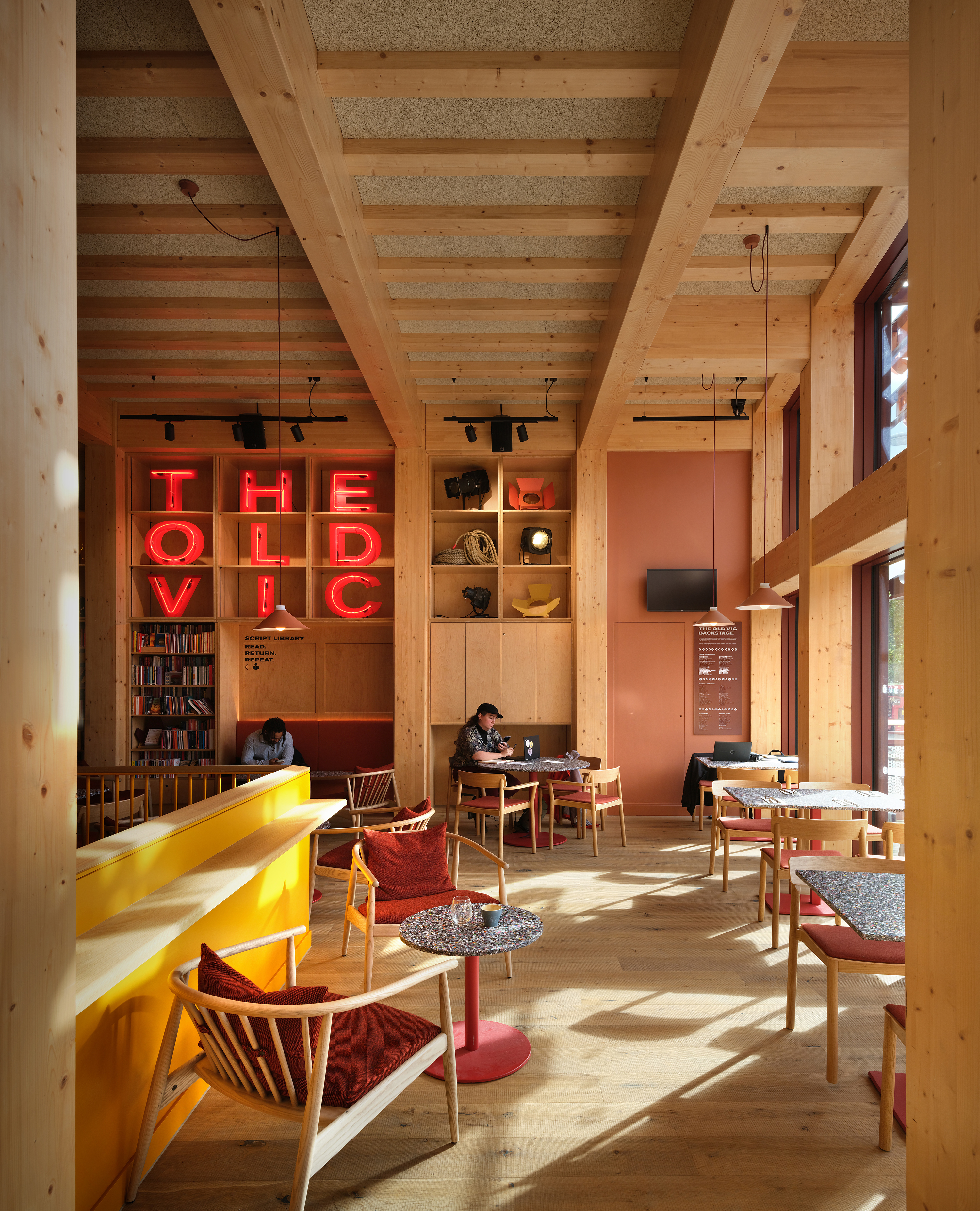Backstage at the Old Vic, colourful spaces in warm terracota colours in a timber framed building