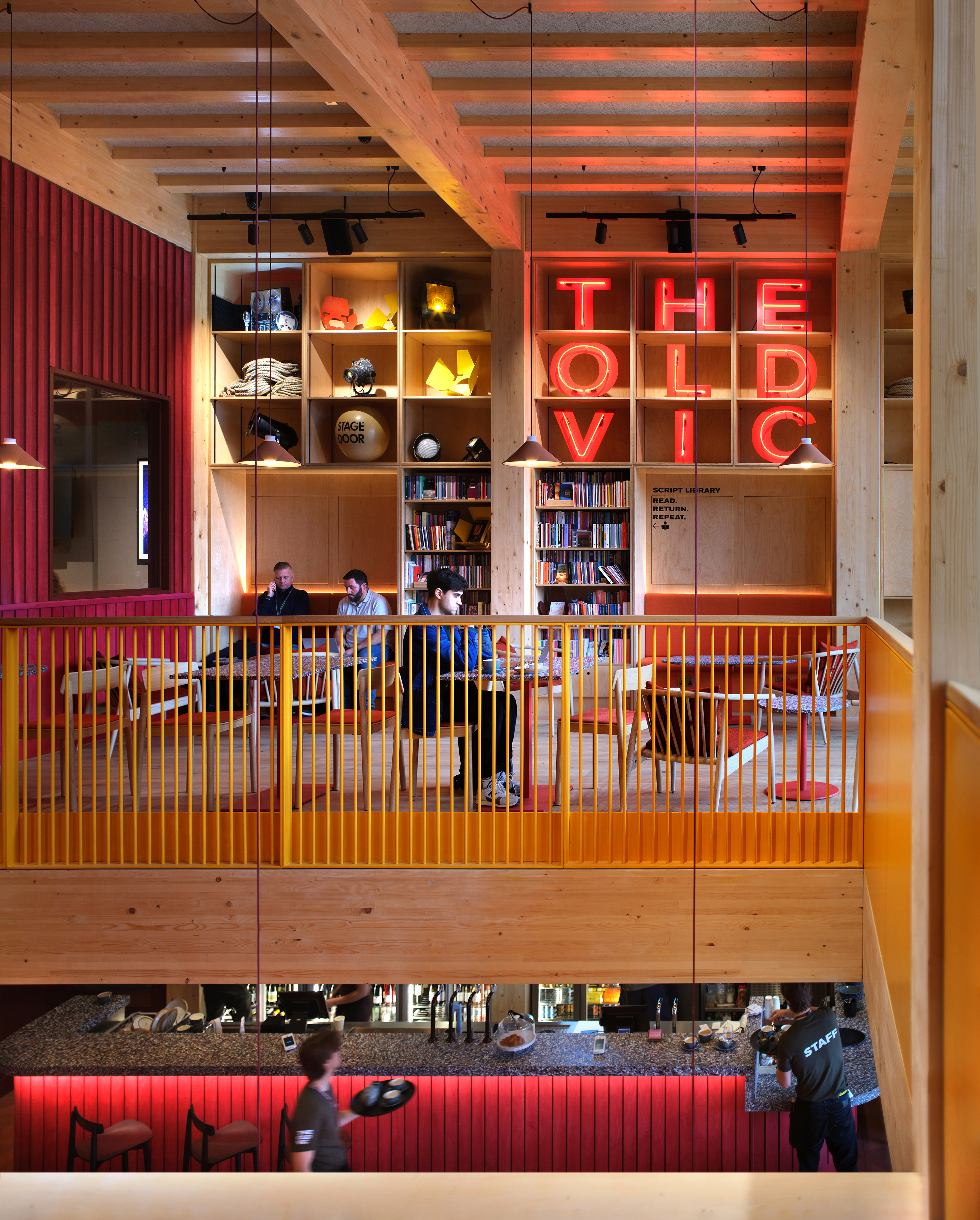 Backstage at the Old Vic, colourful spaces in warm terracota colours in a timber framed building