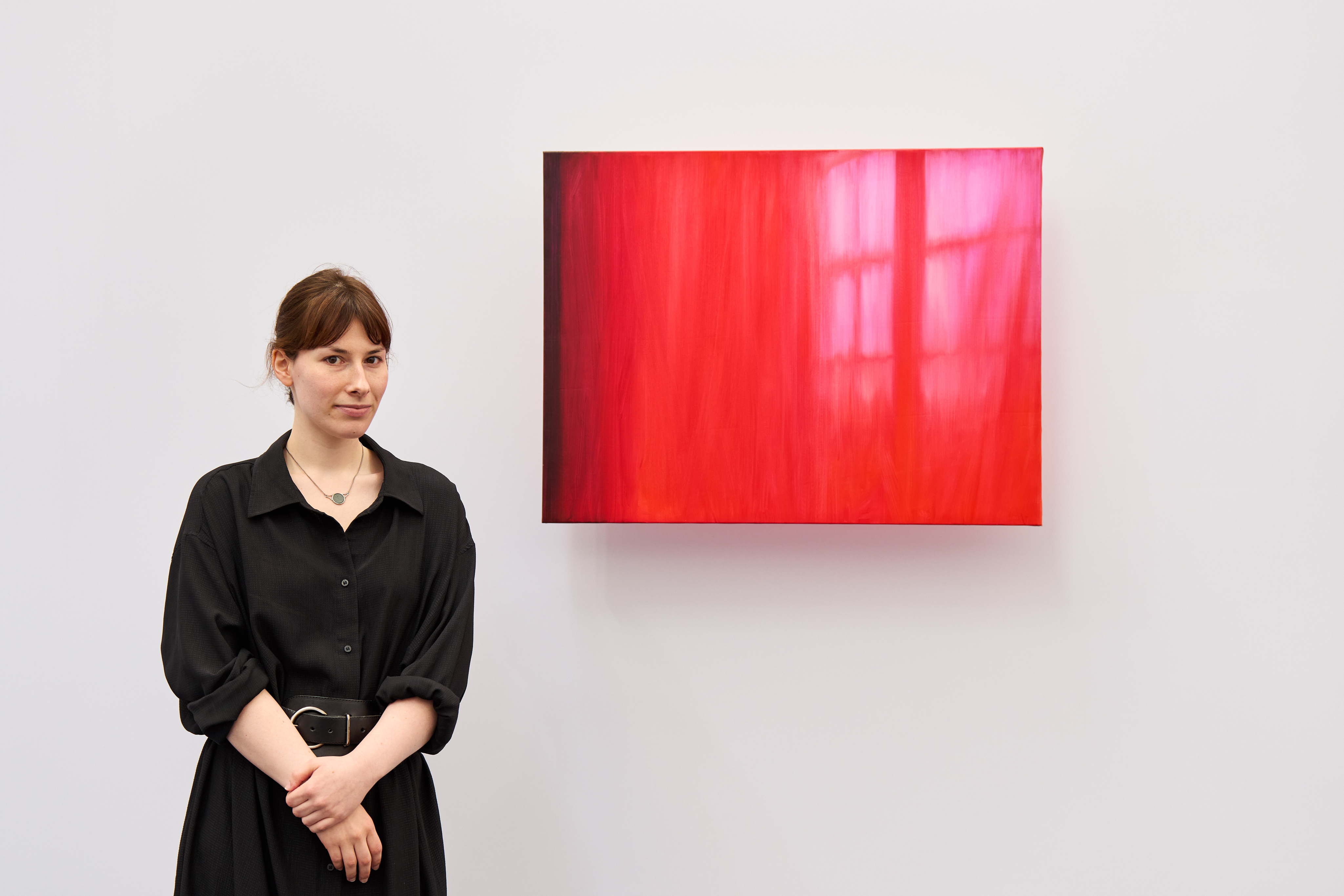 woman in front of pink work