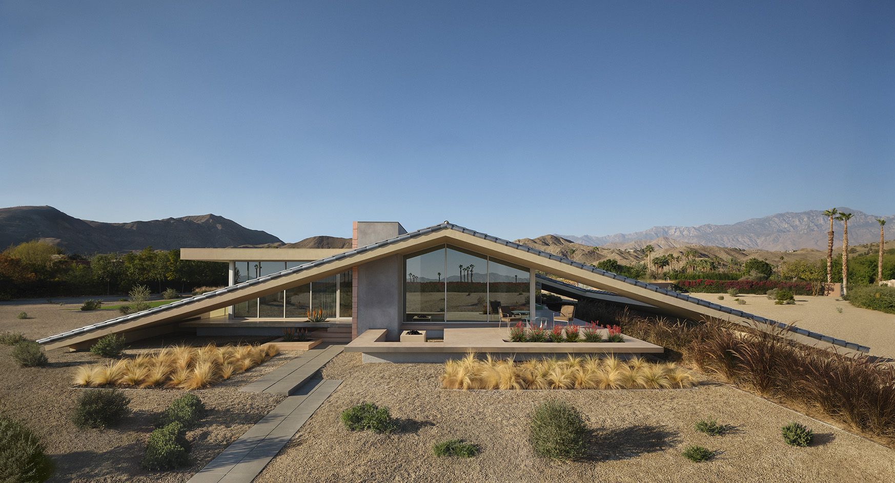 Desert house by Robert Stone, a home made with perforated partitions and an intense pitched low roof
