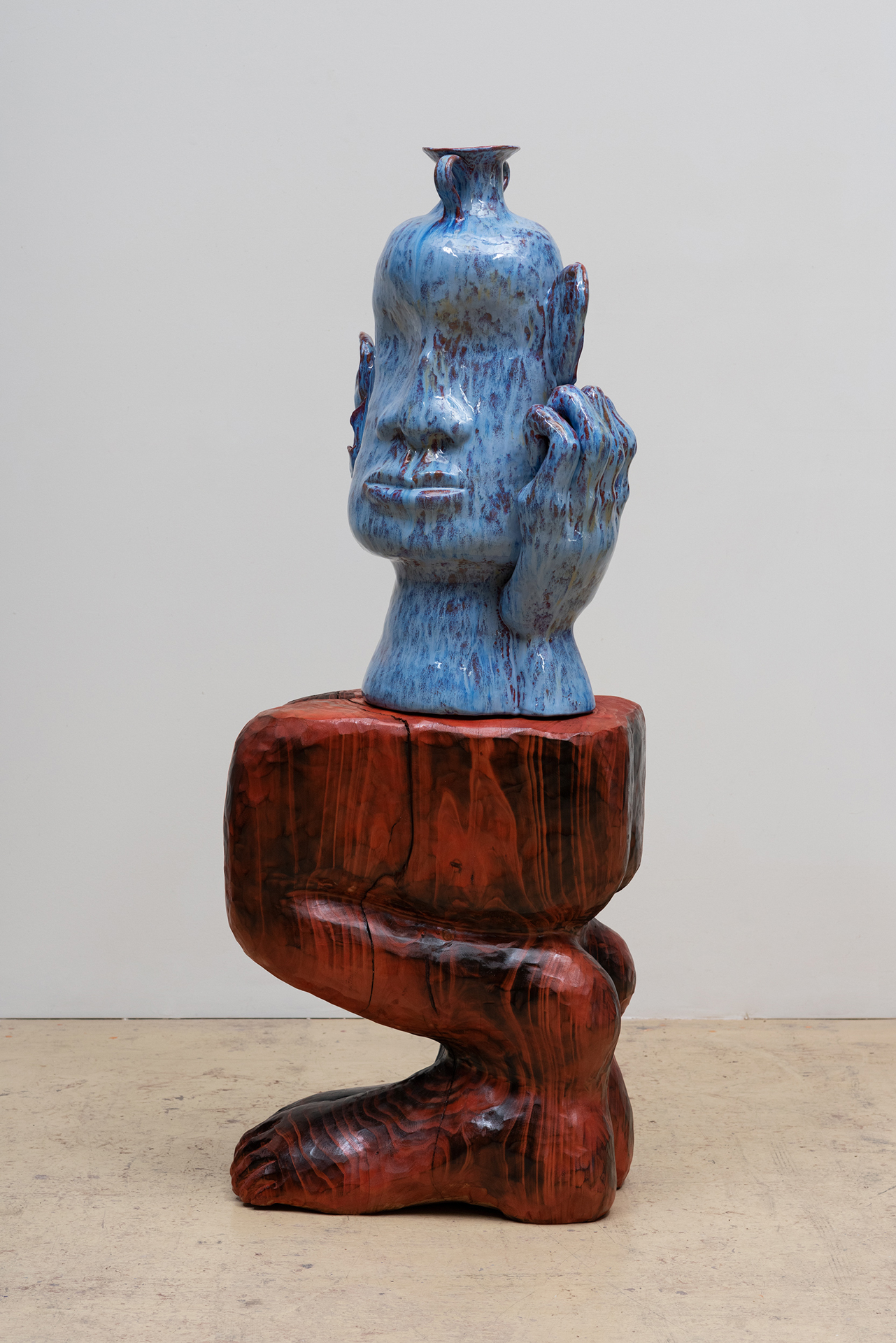 Woody De Othello sculpture of head-shaped vessel on wooden carved based
