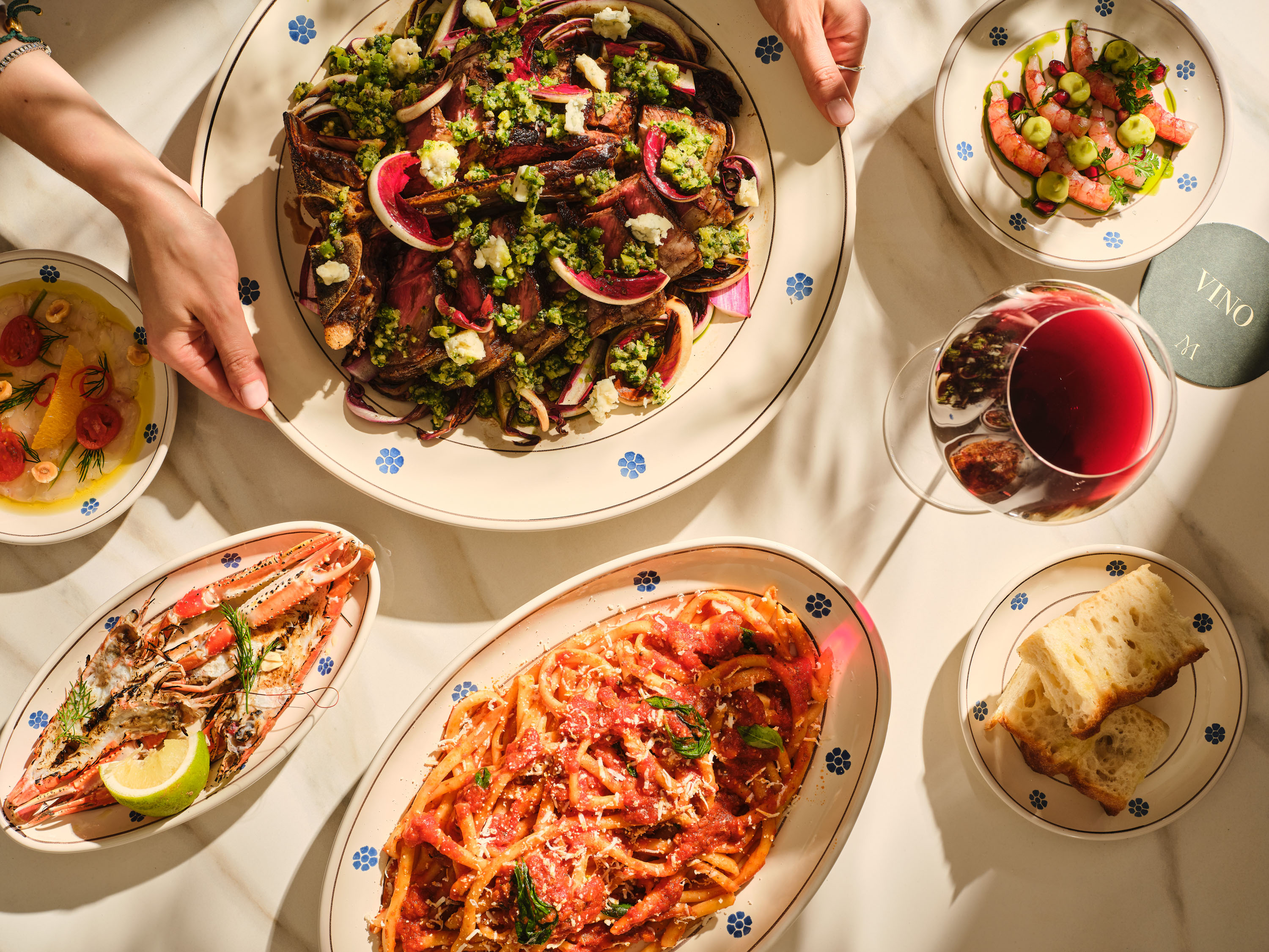 photo of sample dishes at Mezzogiorno restaurant shot from above, lush warm italian past and cakes