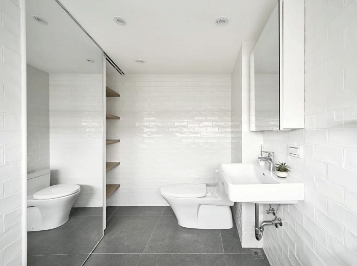 Small studio apartment bathroom design with minimalist white tiles