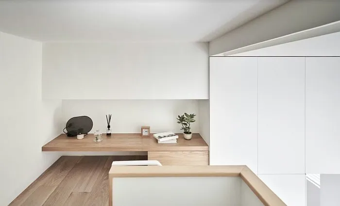 Small studio apartment desk area with built-in shelving