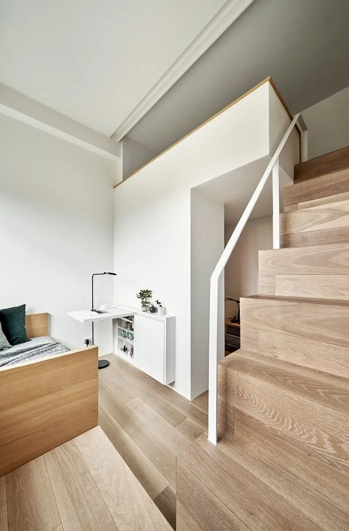 Small studio apartment mezzanine access via compact staircase