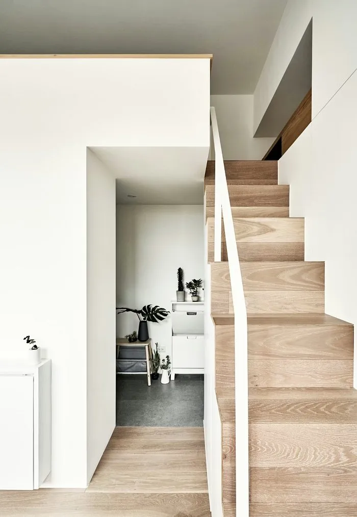Small studio apartment stairs leading to mezzanine bedroom