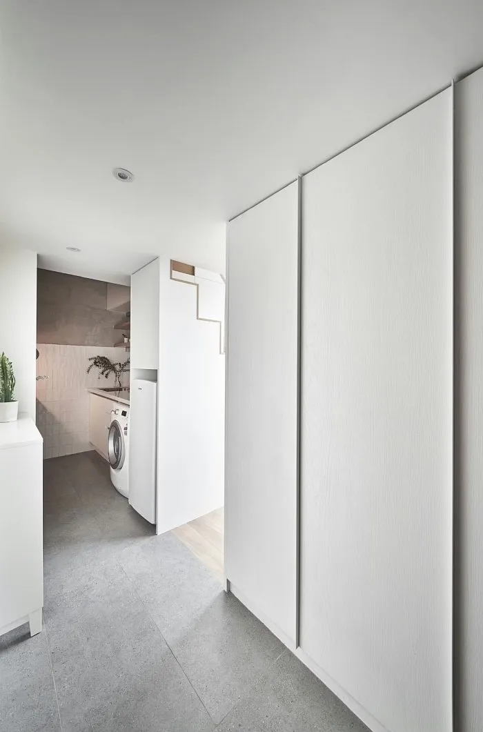 Small studio apartment window seating with built-in bench and storage